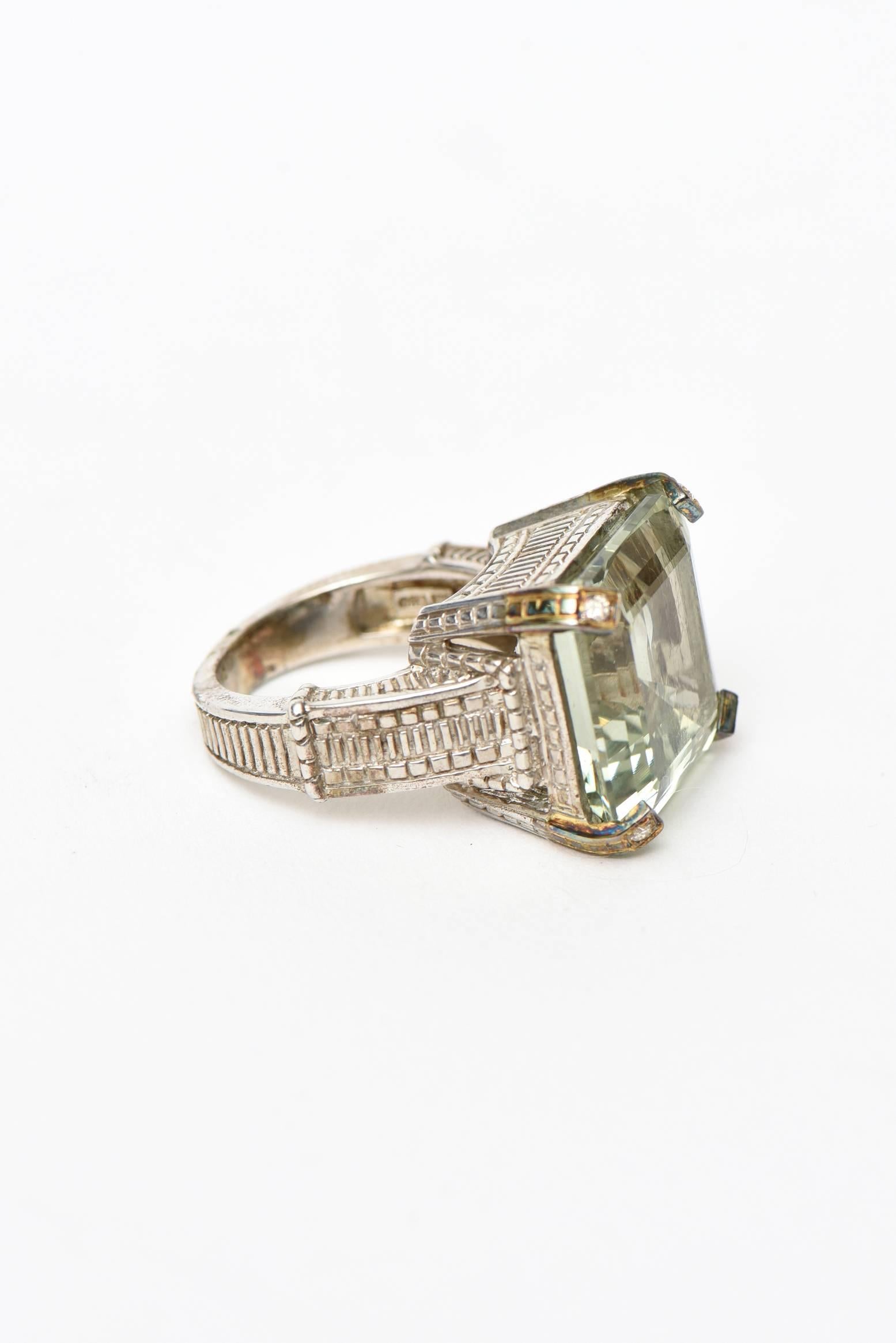 This classic and gorgeous hallmarked Judith Ripka ring has a green faceted square amethyst and 4 tiny diamond on all 4 sides in a sterling silver and 18K white gold  setting. The diamonds are tiny points. It is contemporary and was done most likely