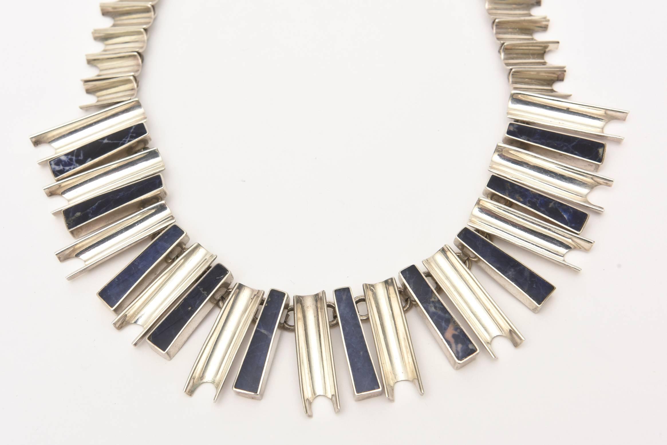 This sculptural and fabulous hallmarked vintage sterling silver and lapis lazuli reticulated necklace is quite stunning on. It has a modernist look. This lays well on the neck. Please note: we have a sterling silver matching bracelet already on line