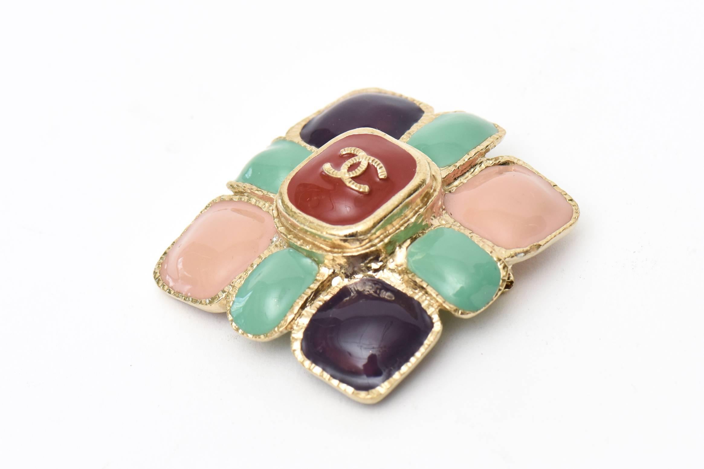This hallmarked chic Chanel multi color pin was for the autumn 2008 collection. It has beautiful subtle colors of purple, blush pink, sage green and rust red admit the gold plated metal. It is signed Made In France 08A.
This would be so beautiful on