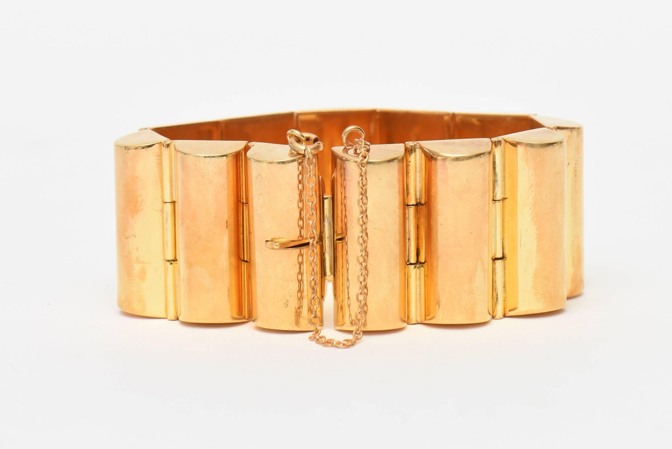This classic and timeless chic real gold plated Art Deco channeled cuff bracelet is for day or evening. It was made to look real. It is from the 30's. It has a safety catch chain and is most likely from the art deco era but retains a modern edge and