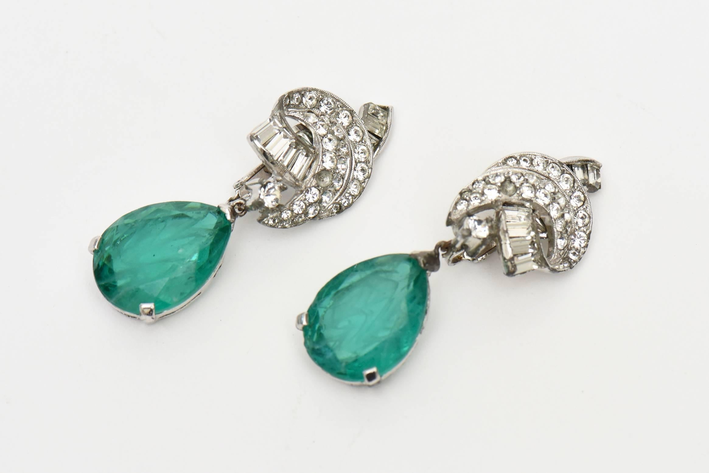 These beautiful and real like signed vintage Panetta pair of clip on dangle/ drop earrings are the color of green emerald glass and clear rhinestone that looks like diamonds and baguette diamonds. They were made to look real and are regal looking.