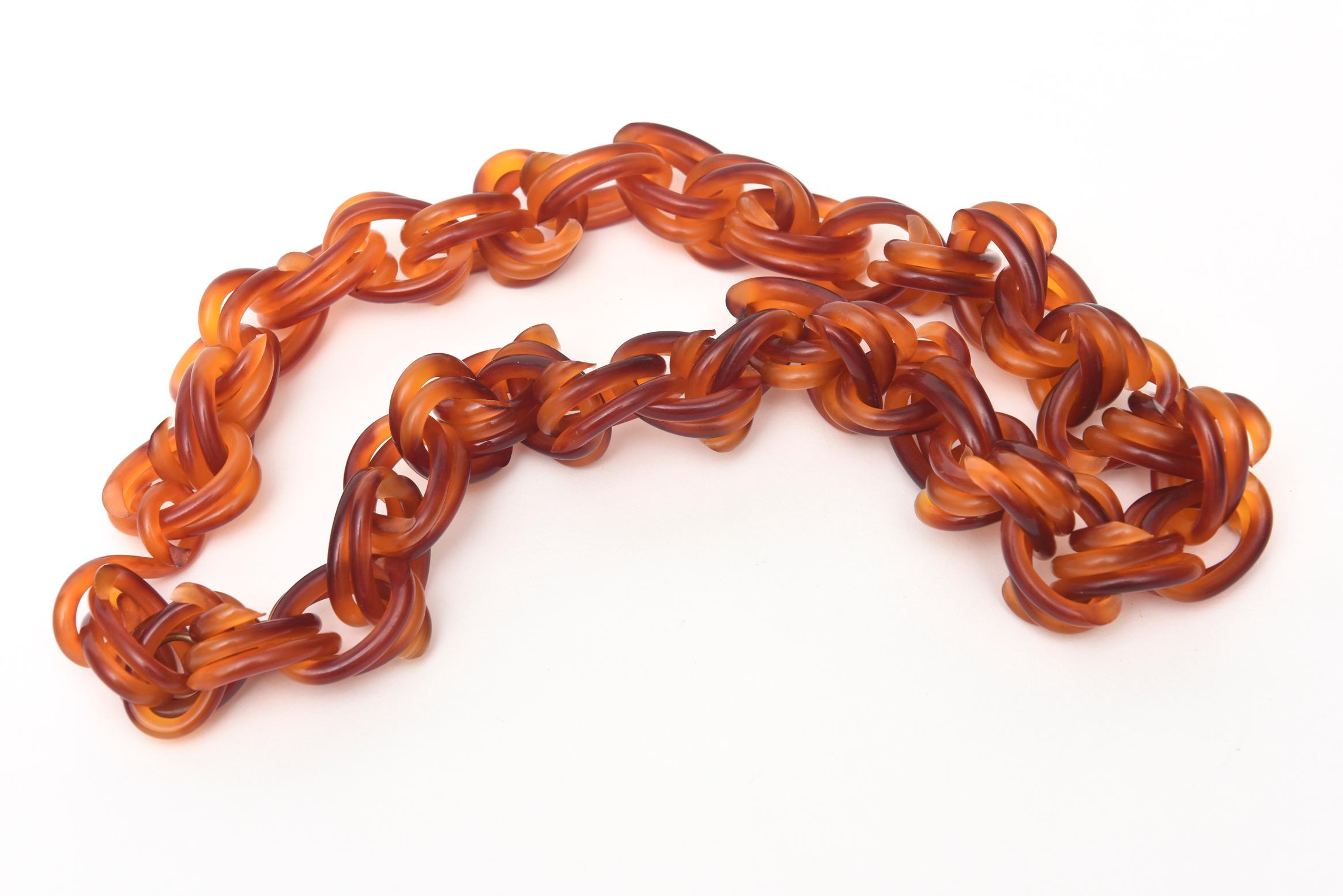 This lovely twisted lucite amber brown toned lucite link necklace is perfect for 2020. It is from the 70's. This looks so chic with white!