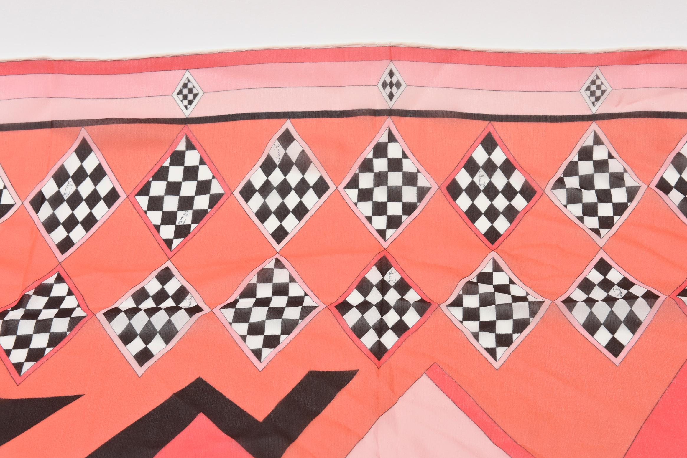 This fabulous 1960's Italian vintage Emilio Pucci silk chiffon scarf has beautiful colors and checkerboard black and white diamond patterns with luscious colors of pink and coral. It has all the original vintage 4 labels on the side of the scarf.