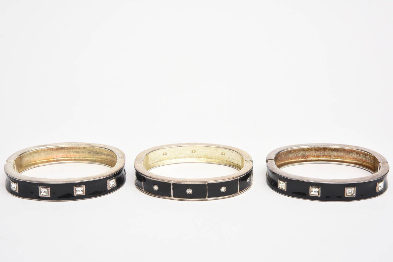 This set of three elegant bangle bracelets that are black enamel and clear rhinestones with a hinged closure. They fit well on the wrist. It takes a small wrist of size 6 or size 6.5 They are timeless and can go day to night. They are gorgeous with