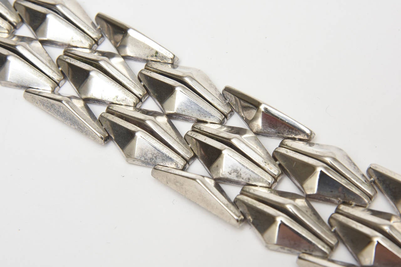 This fabulous vintage Italian geometric and sculptural vintage 3 row hallmarked sterling silver Italian bracelet is marked 925 with an M encased in a box. The was finely made by an artisan from the time period of the 60's. It has a safety clasp. We