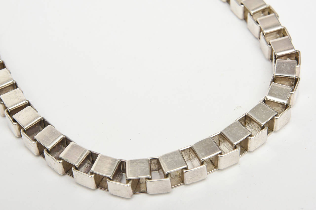 This substantial sculptural Italian hallmarked vintage sterling silver interlocking geometric cube necklace is quite fabulous. It sits and lays shorter on the neck. It has a safety catch to close it. Signed 925 Italy. It has great weight to it and