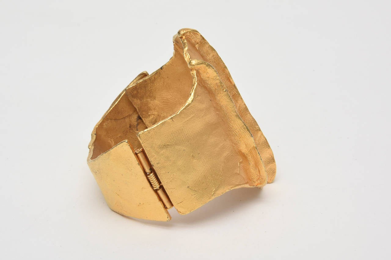 This french hand wrought and studio made gold plated cuff bracelet is signed Dauplase. It has a rich look to it and fits on the wrist beautifully. It is modern yet rings other centuries of by gone times. That is the special and beautiful mix. It has