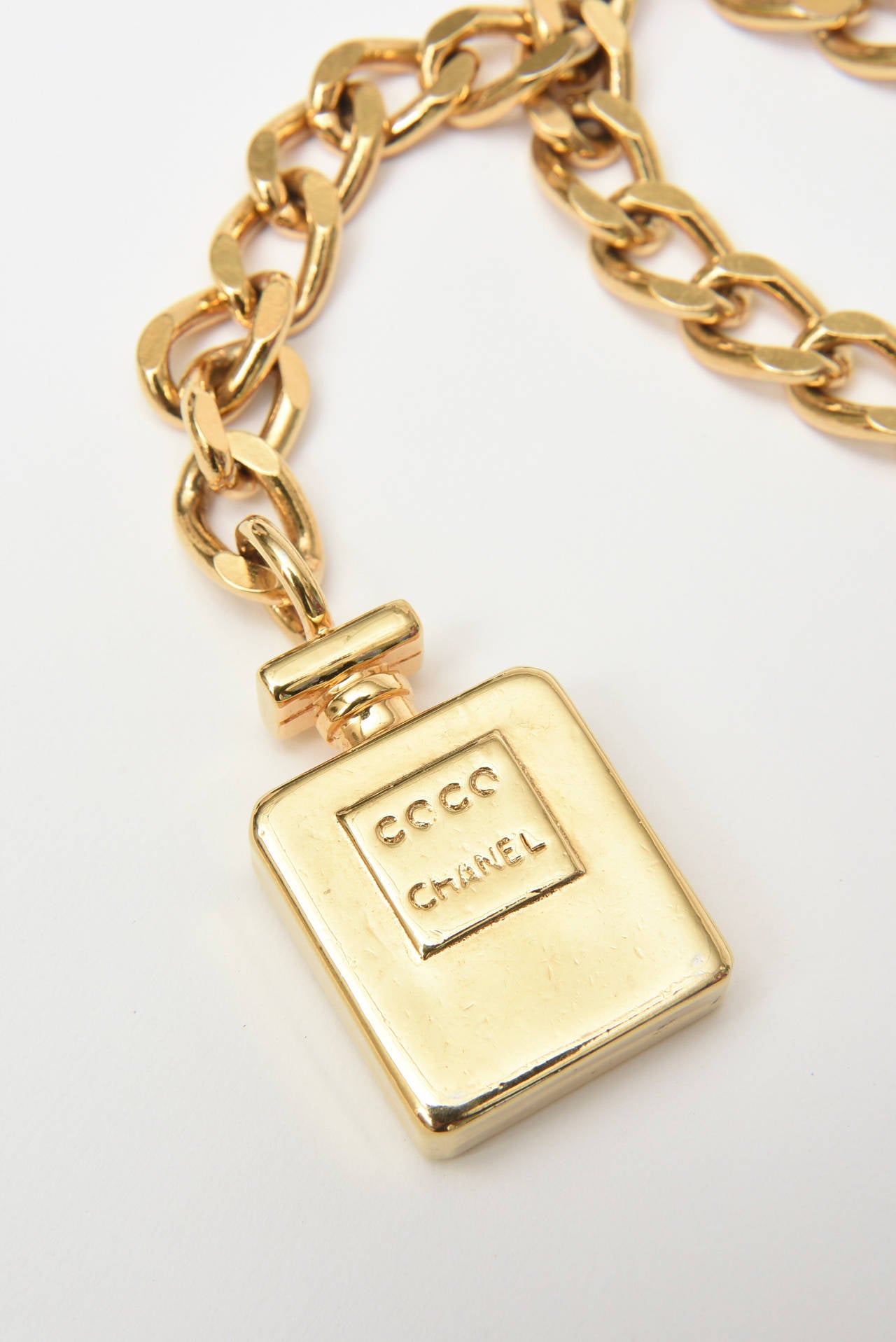 This heavy versatile Chanel gold plated chain link belt has the dangling bottle of the iconic Coco Chanel perfume 5