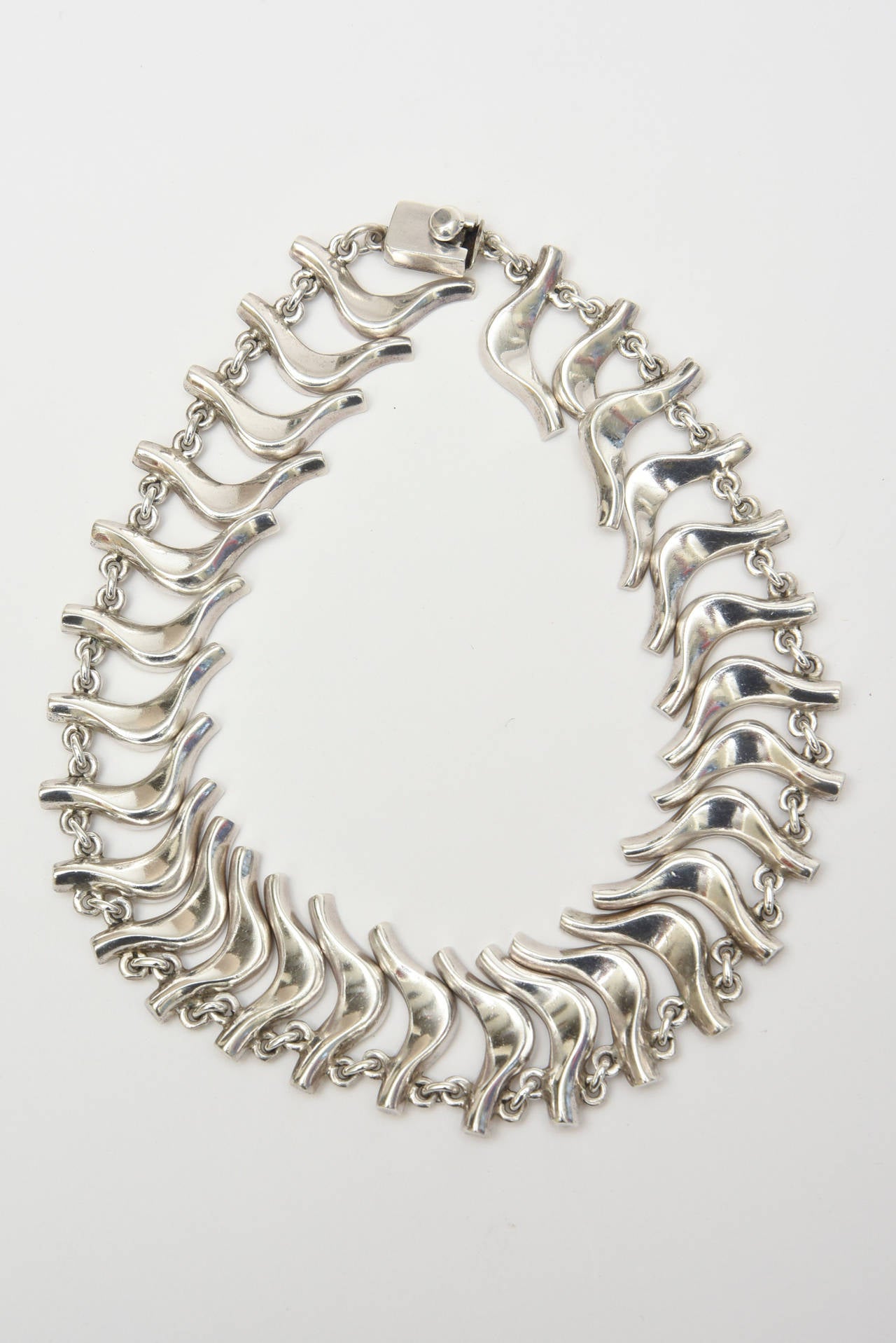 This set of a sterling silver vintage Mexican Collar necklace and bracelet has abstract dancer like forms. It is hallmarked 