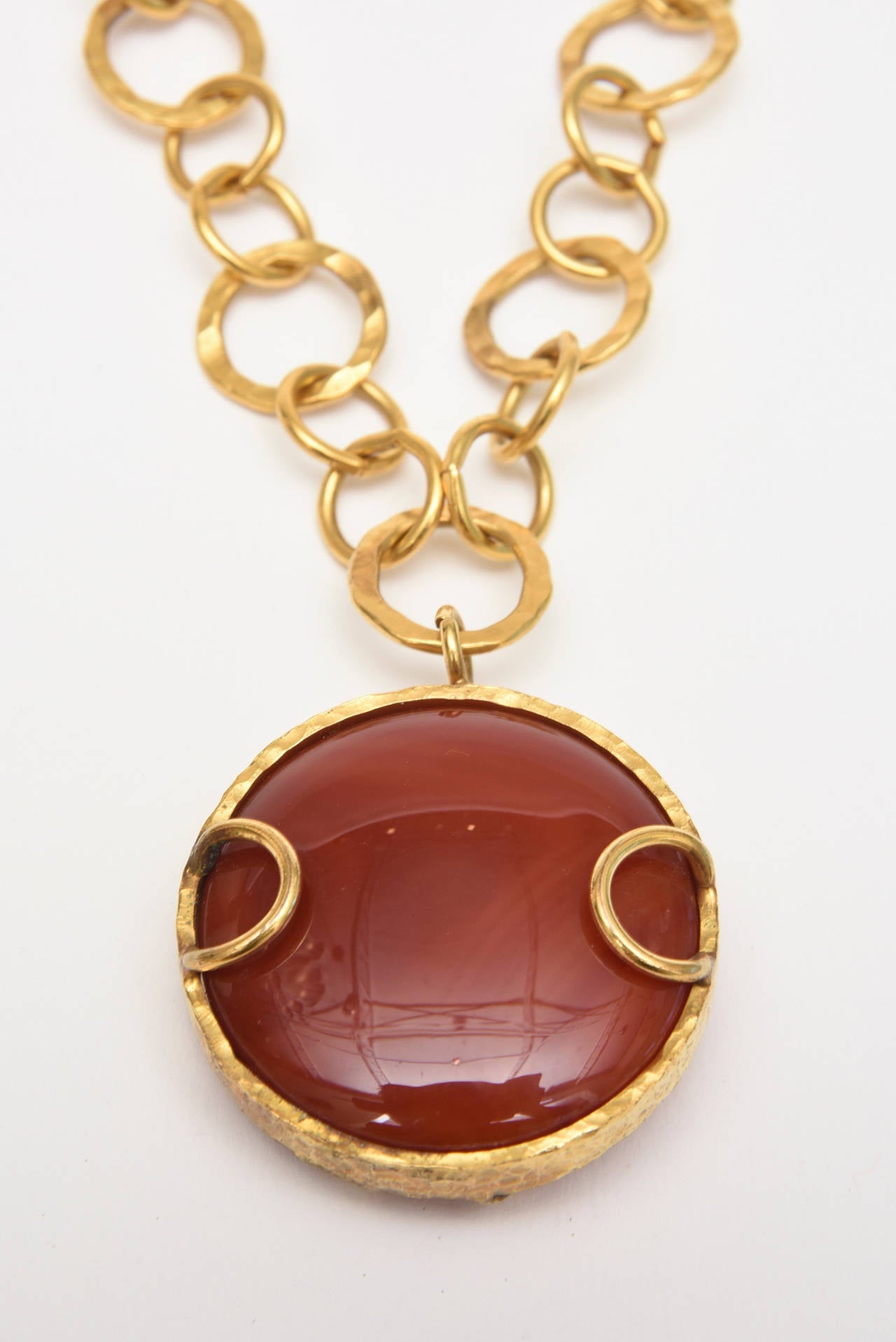 This lovely hand hammered one of a kind vintage gold plated chain link loop necklace with a big carnelian disk stone is signed Sharron Yarro. The hand crafted hand hammered detail is beautiful. It can be worn long or can be wrapped twice around for