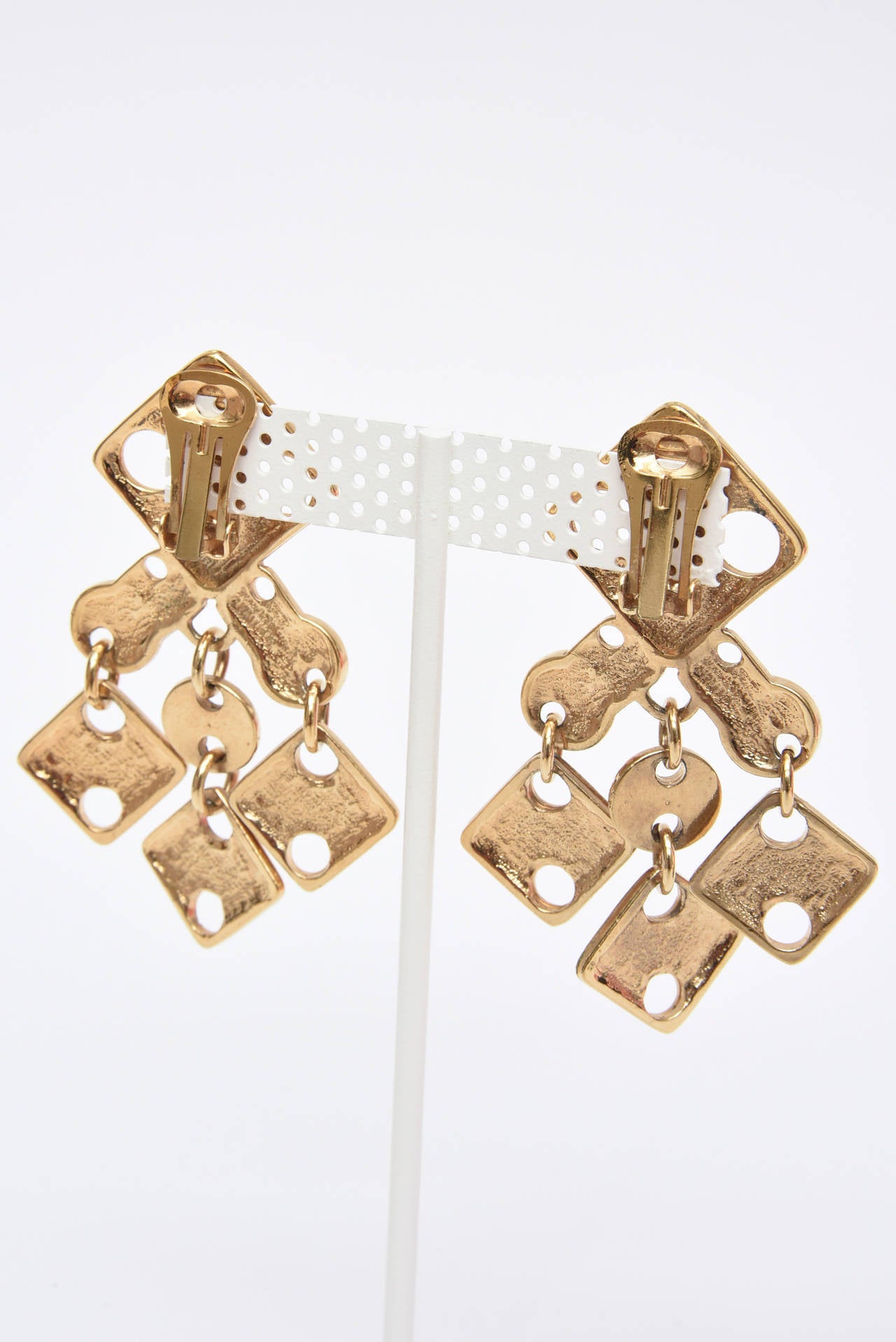 These fabulous and amazing signed vintage French Paco Rabanne modernist dangle sculptural earrings are so au courant now as they were then in the 60's. The geometric cutout forms and angles will forever be in stye. They are gold plated brass and