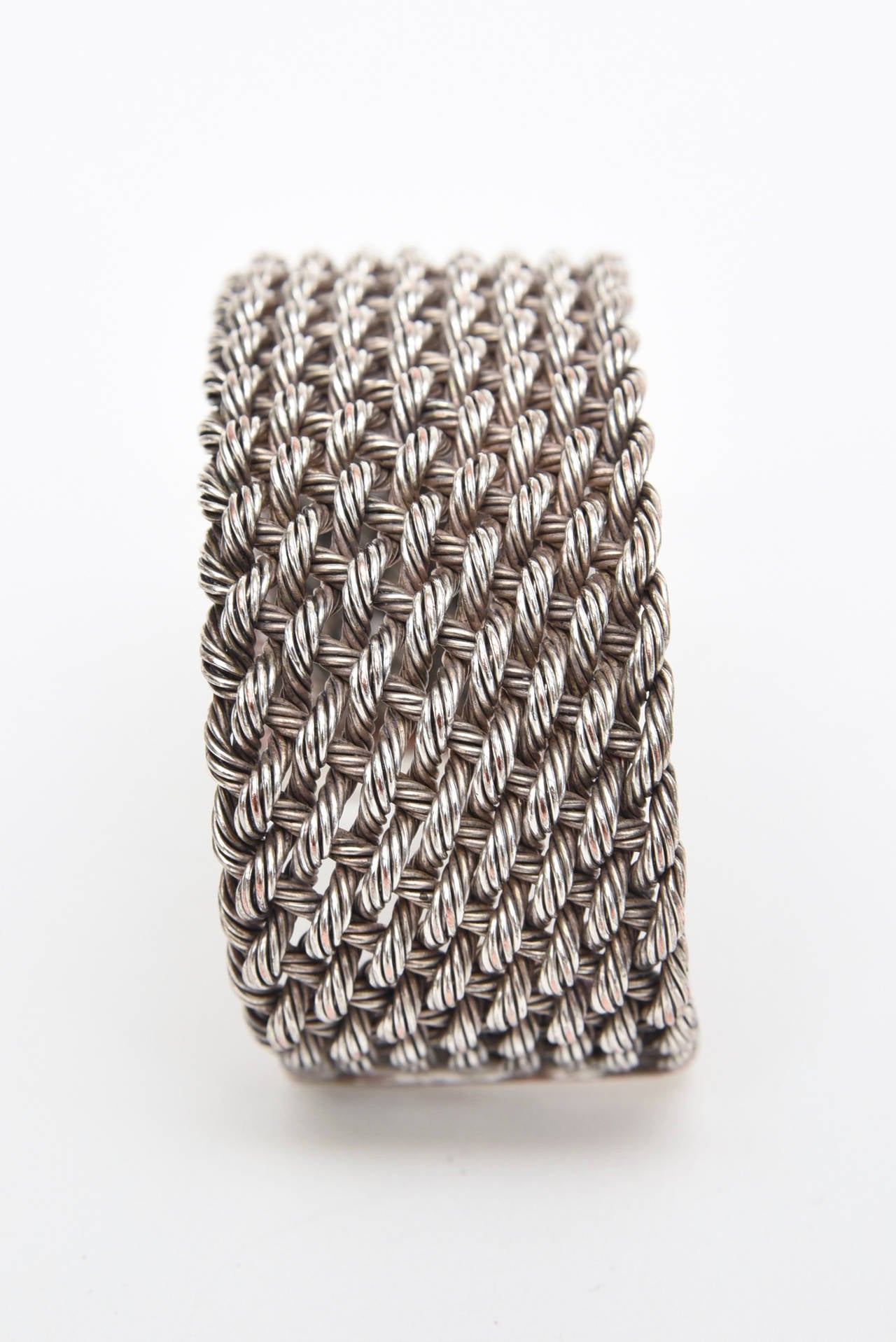 This lovely sterling silver cuff bracelet has nice braided woven sterling silver that has the original patina. The detailing is wonderful and presents on the wrist a great design. It will fit a medium to larger wrist. That size would be a size 7,