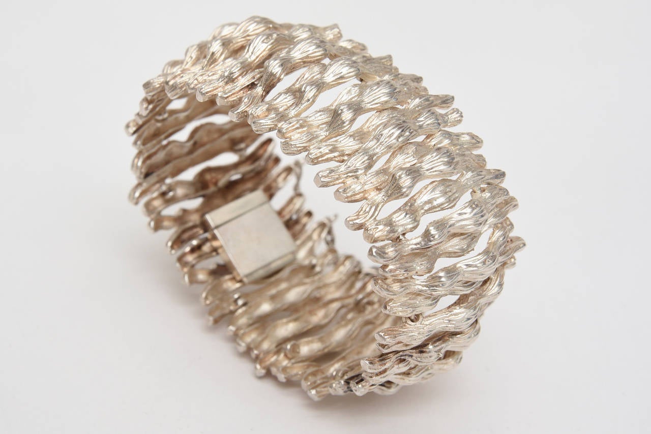 Organic meets modern with dimensional and textural design that resembles bark on a tree in this vintage sterling silver cuff bracelet.  Quite stunning on with a natural patina. It is from the 60's. It is hallmarked and signed but not legible. There