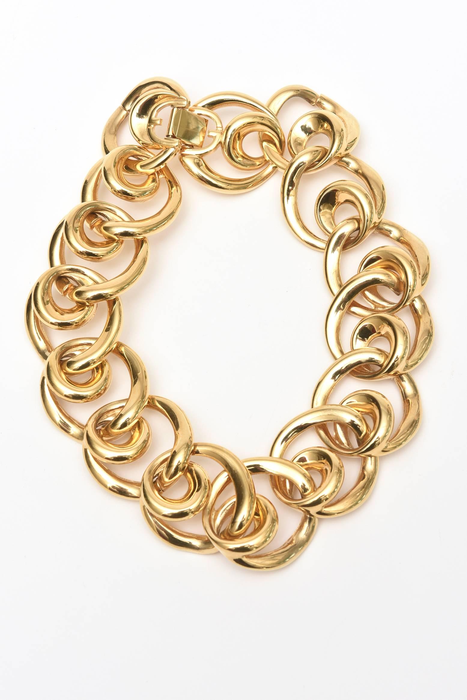 This timeless and au courant marked vintage Givenchy collar necklace with it's overlay connecting beautiful gold plated large links has a matching pair of clip on earrings, sold as a set. Please. They can be worn separately. The substantial large