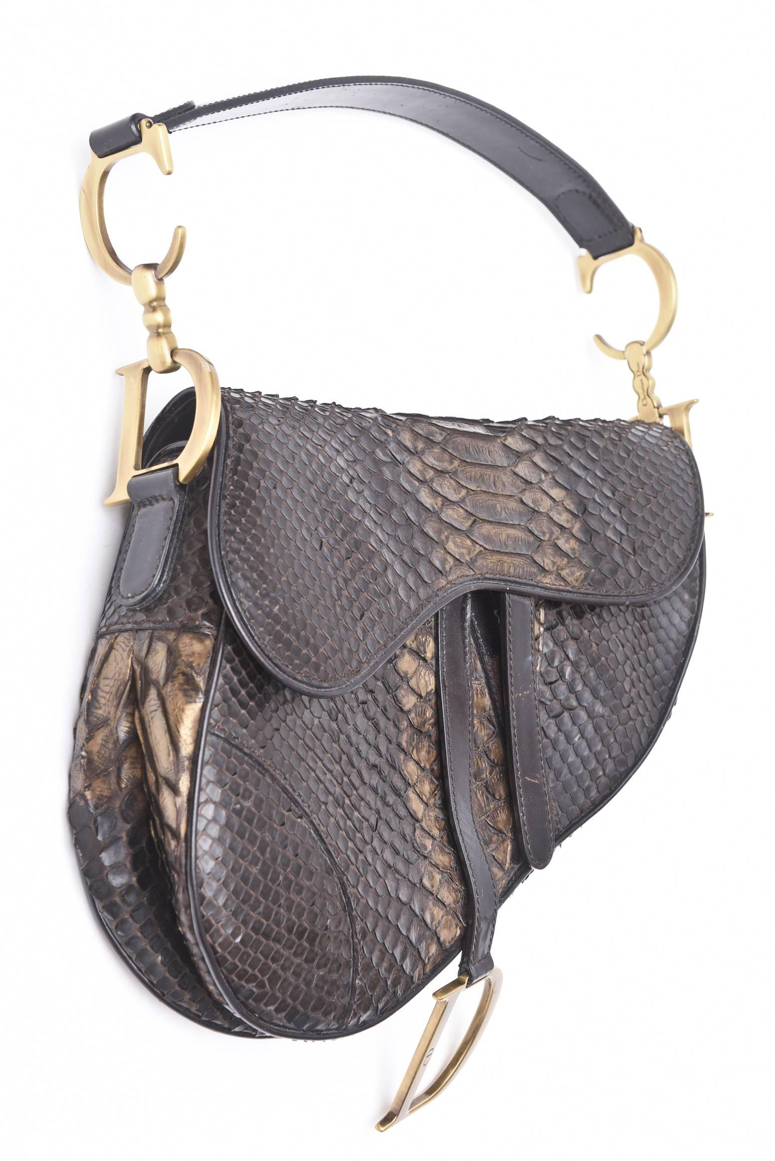 This stunning and luxe real python saddle bag/ handbag is a collectors piece. This was the first bag  designed by John Galliano for Christian Dior in the early 80's. To note... Christian Dior never does chocolate brown... It is a limited edition