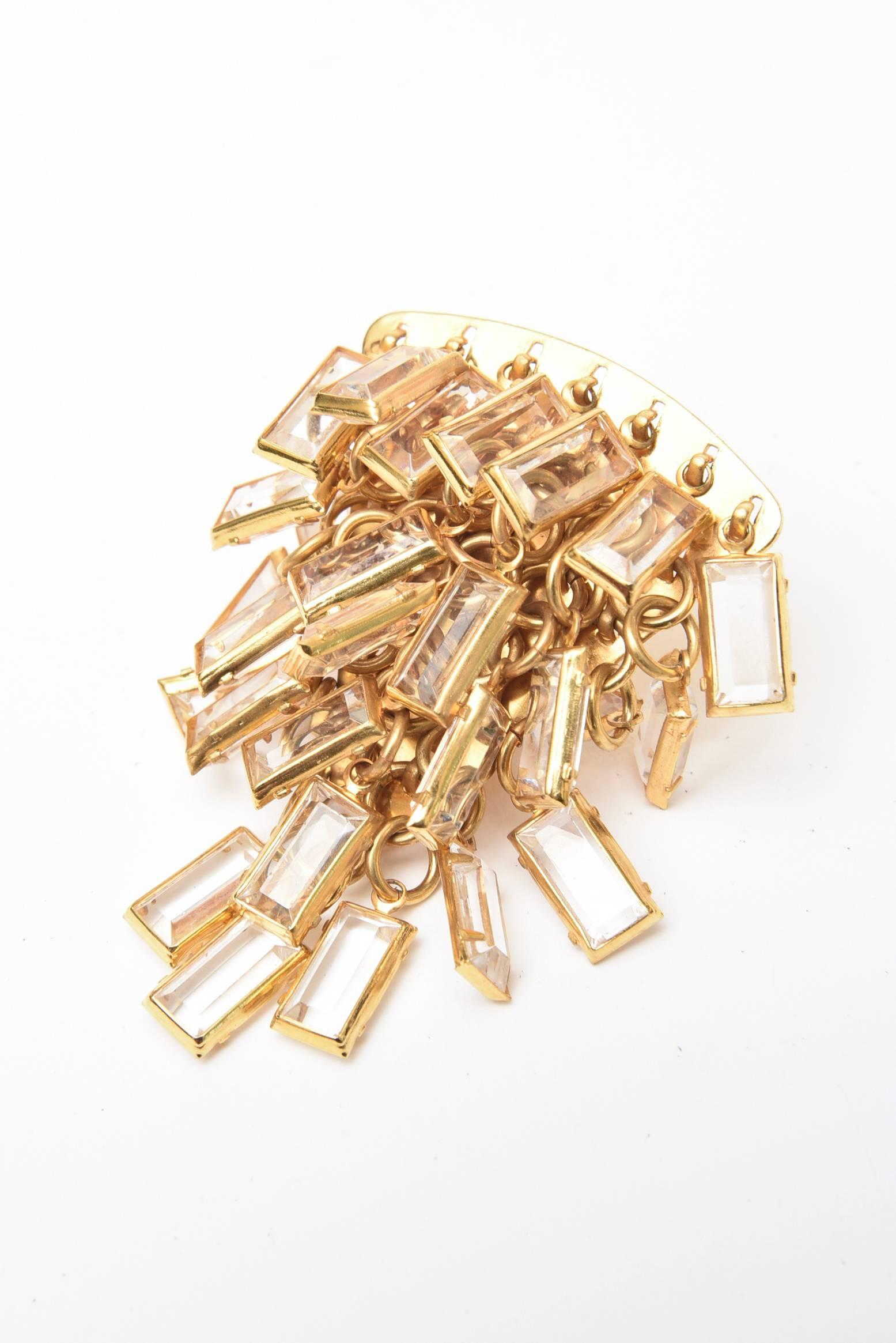  These wonderful and dramatic Italian vintage cascading pair of clip on earrings are composed of tiered small glass chips surrounded by brass. These are perfect for the evening out dinner, cocktail hour and evening attire. Very eye catching on the