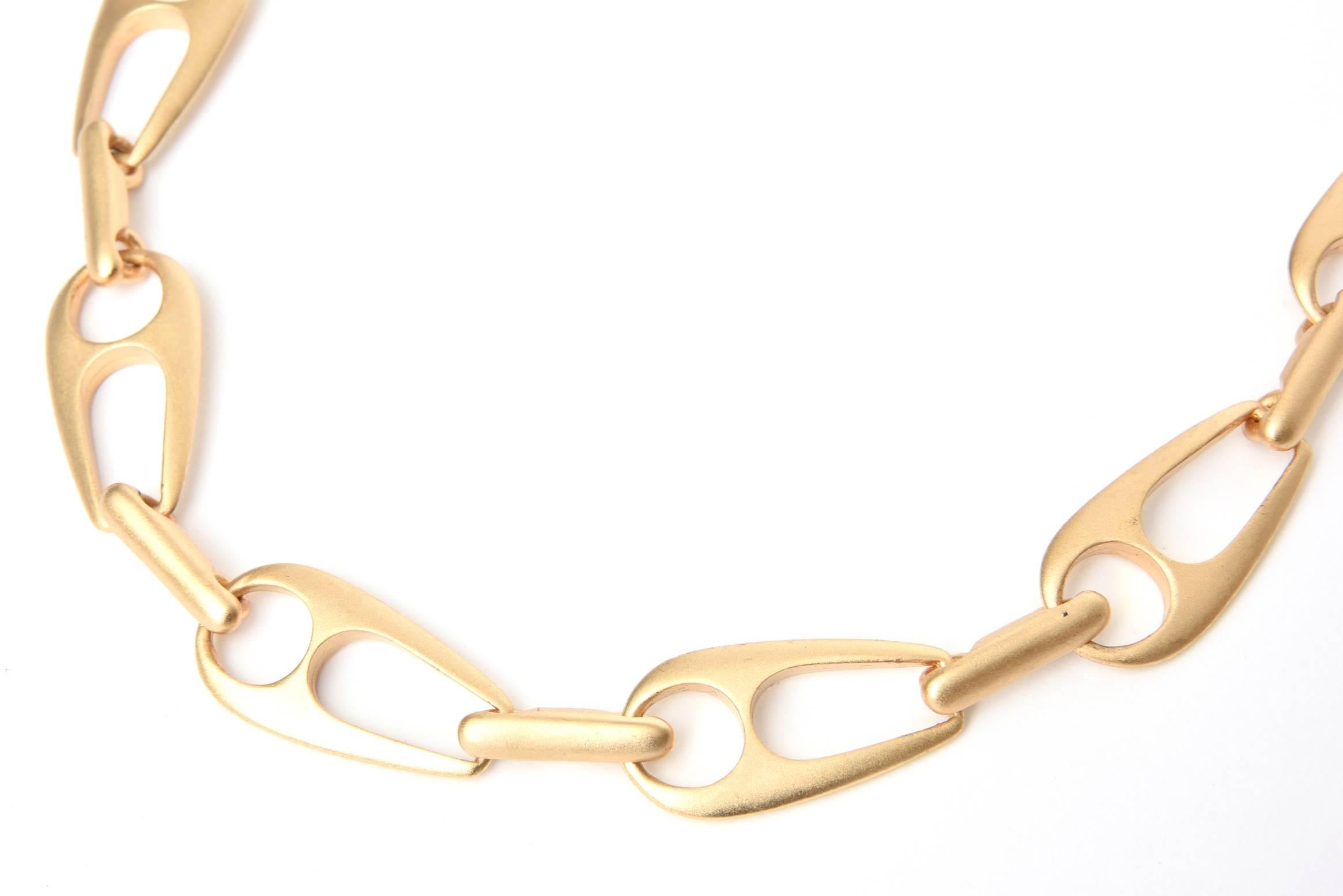 This wonderful satin gold plated chain necklace is Gucci Inspired and has been attributed to Alexis Kirk, although it is unsigned. It is sculptural and modern. It has good weight to it. Each link is one inch wide, by 1.85 inches long. It is 14