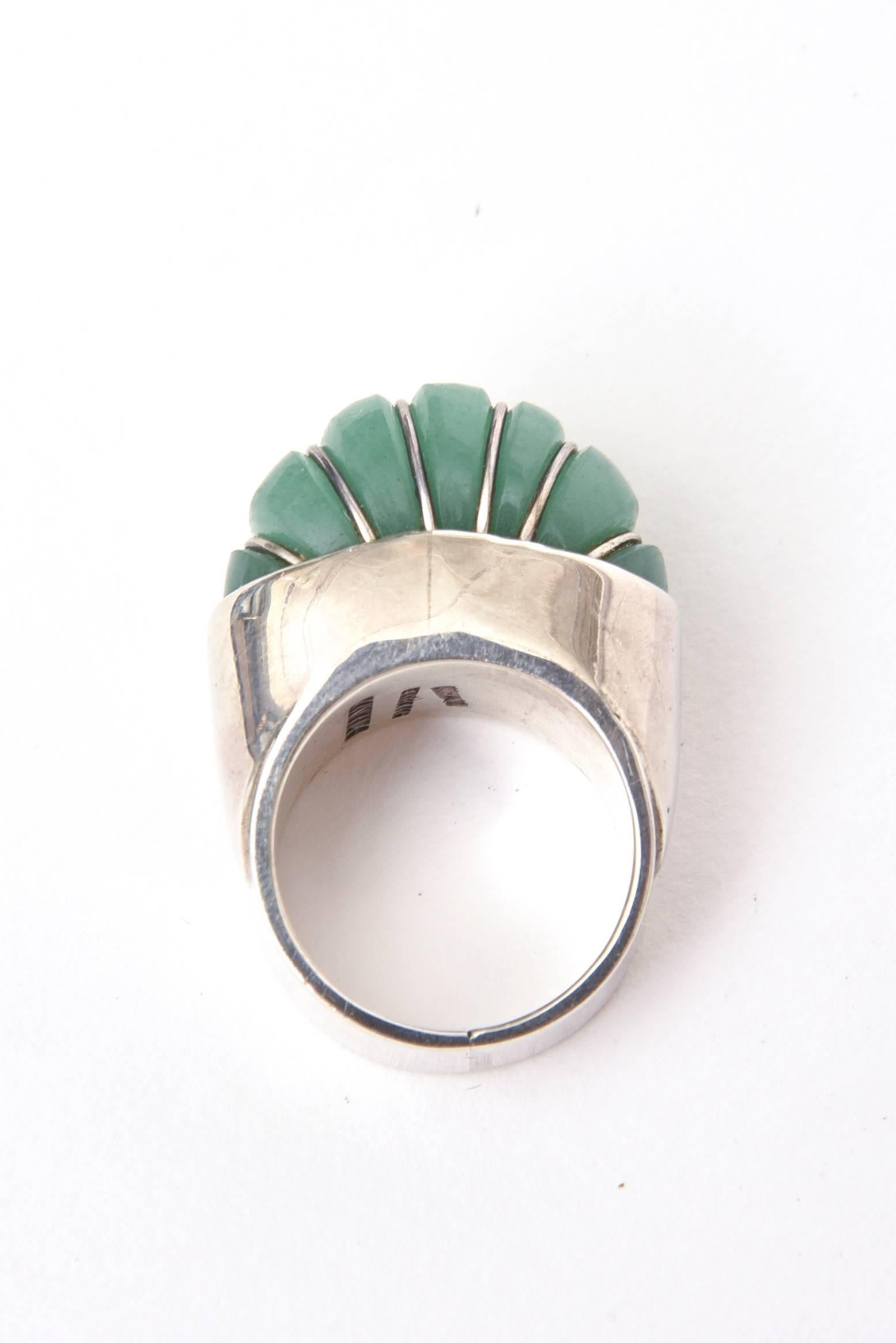 Unique petals of Jade on this ring sit high against the Sterling Silver. 
It is sculptural and dimensional.
The ring has height on your finger and sits high.
The ring size is 8.25. It can always be sized to your specifications at your end.
It is all