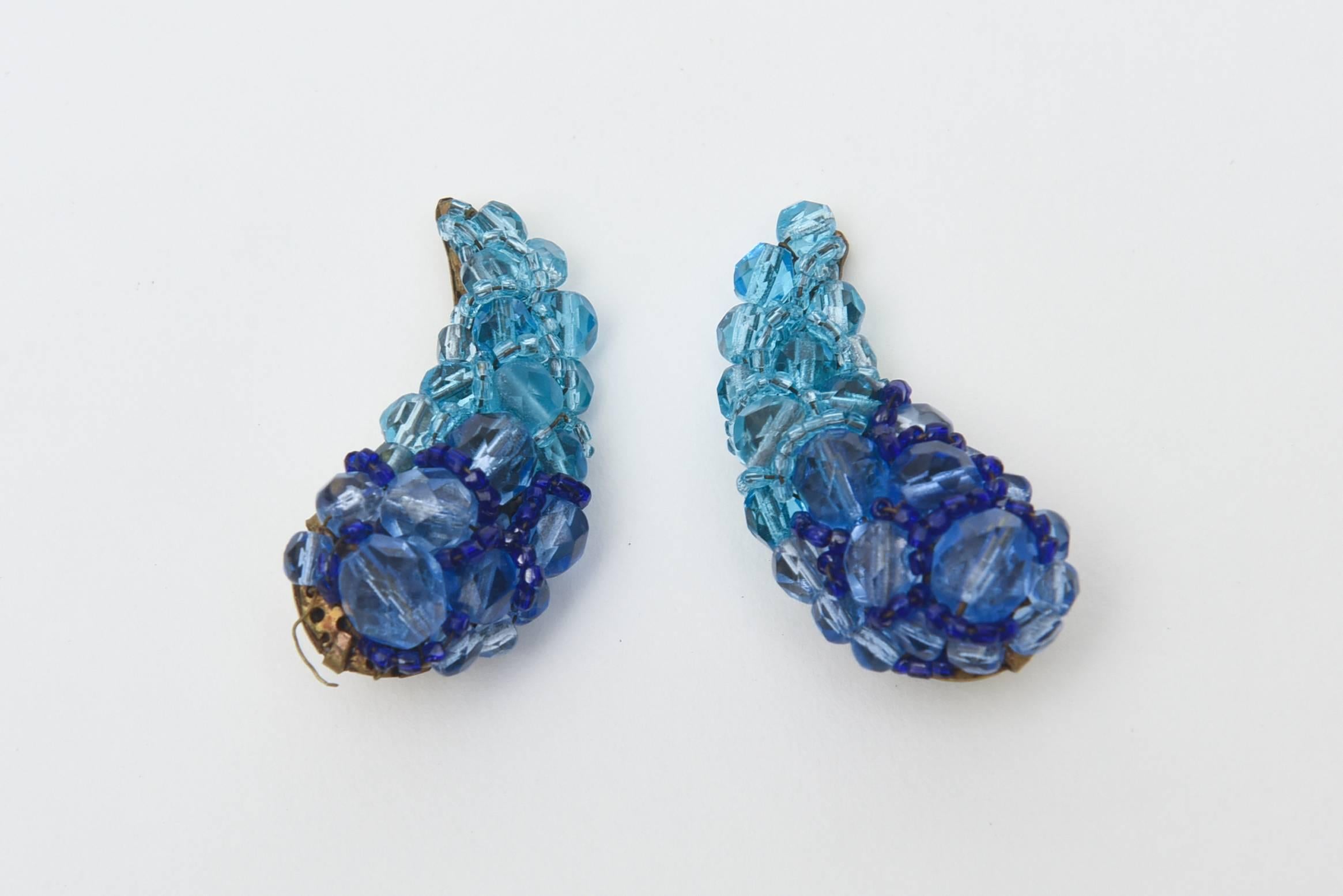 These stunning two tone pair of signed Italian Coppola E Toppo Venetian glass beaded clip on earrings are two toned shades of blue. Like the sky and the sea combined they make a luscious appearance on the ear. These stellar pair of clip on glass