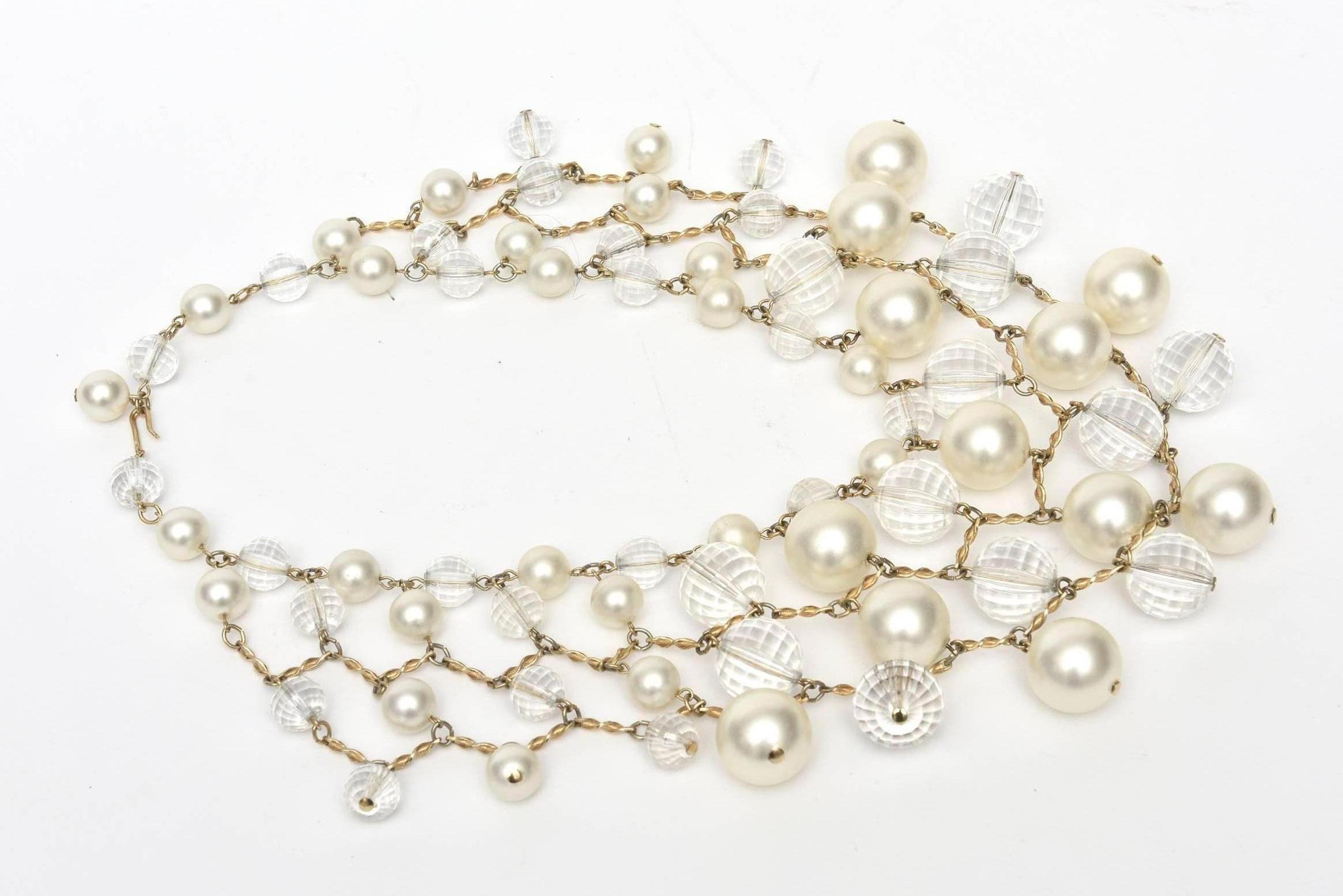 This dramatic and elegant vintage faux pearl,  faceted lucite and brass multi strand bib necklace is a forever statement piece. It lays beautifully on the neck and can go any season from day to evening! This will dress up your cocktail dress, shirt