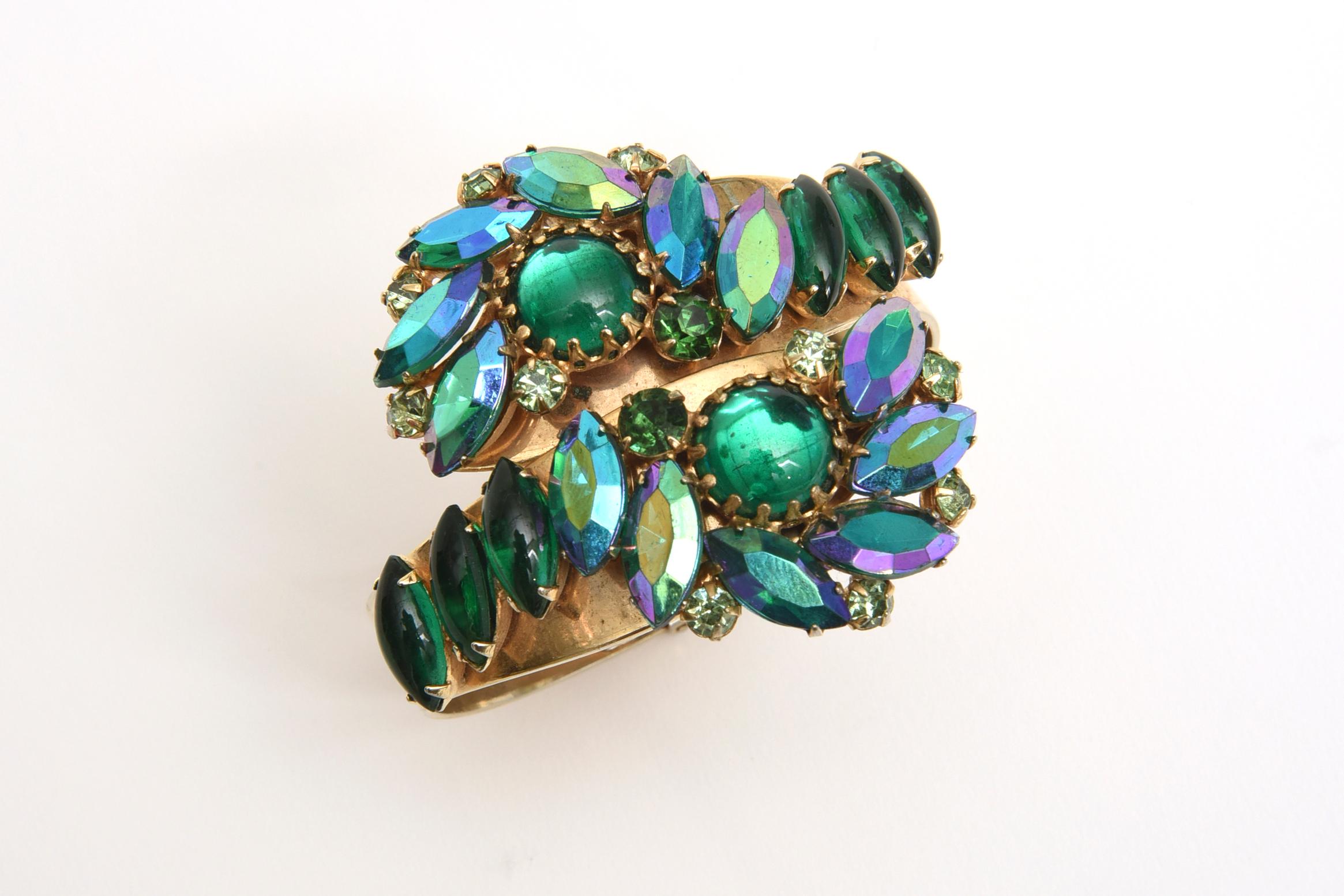 Stunning colors of greens and turquoise of the Aurora Borealis crystals make up this this Alice Caviness mid century modern vintage gorgeous twisted clamp bracelet. It is like the brilliant colors of the sea exaggerated in luminosity and brilliance