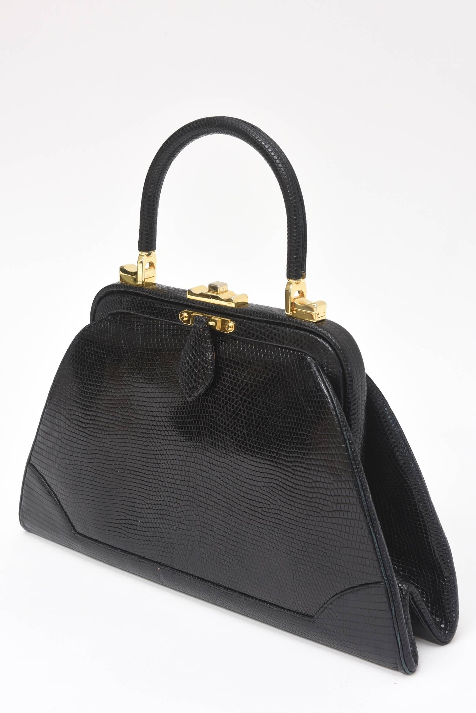 This classic and timeless vintage Judith Leiber black lizard Kelly handbag is forever. The condition is fantastic and the beautiful gold tone clasp and hardware is in great condition; like almost never used. The shape, the style it is forever. This