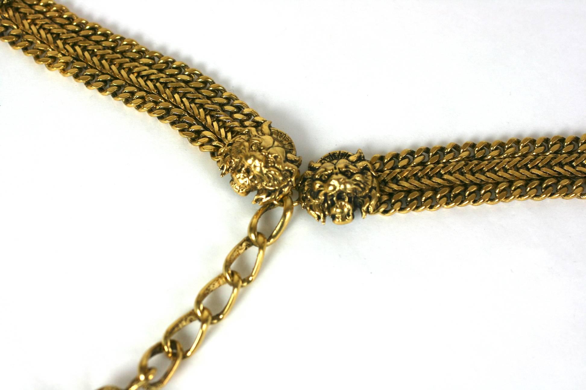 CoCo Chanel early chain belt composed of signature curb chain with classic signature lions head motifs terminating in an adjustable pendant tassel. 
Coco Chanel synthesizes her favorite lion motif,  one of the codes deeply rooted to the House of