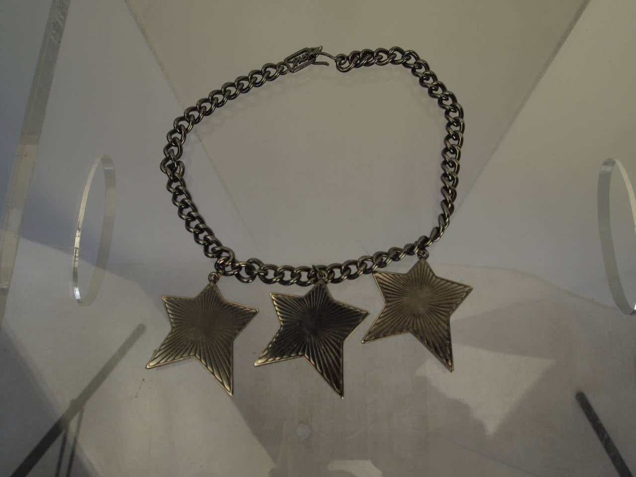 Yves Saint Laurent chain necklace with green, red and yellow enameled stars and hook closure.