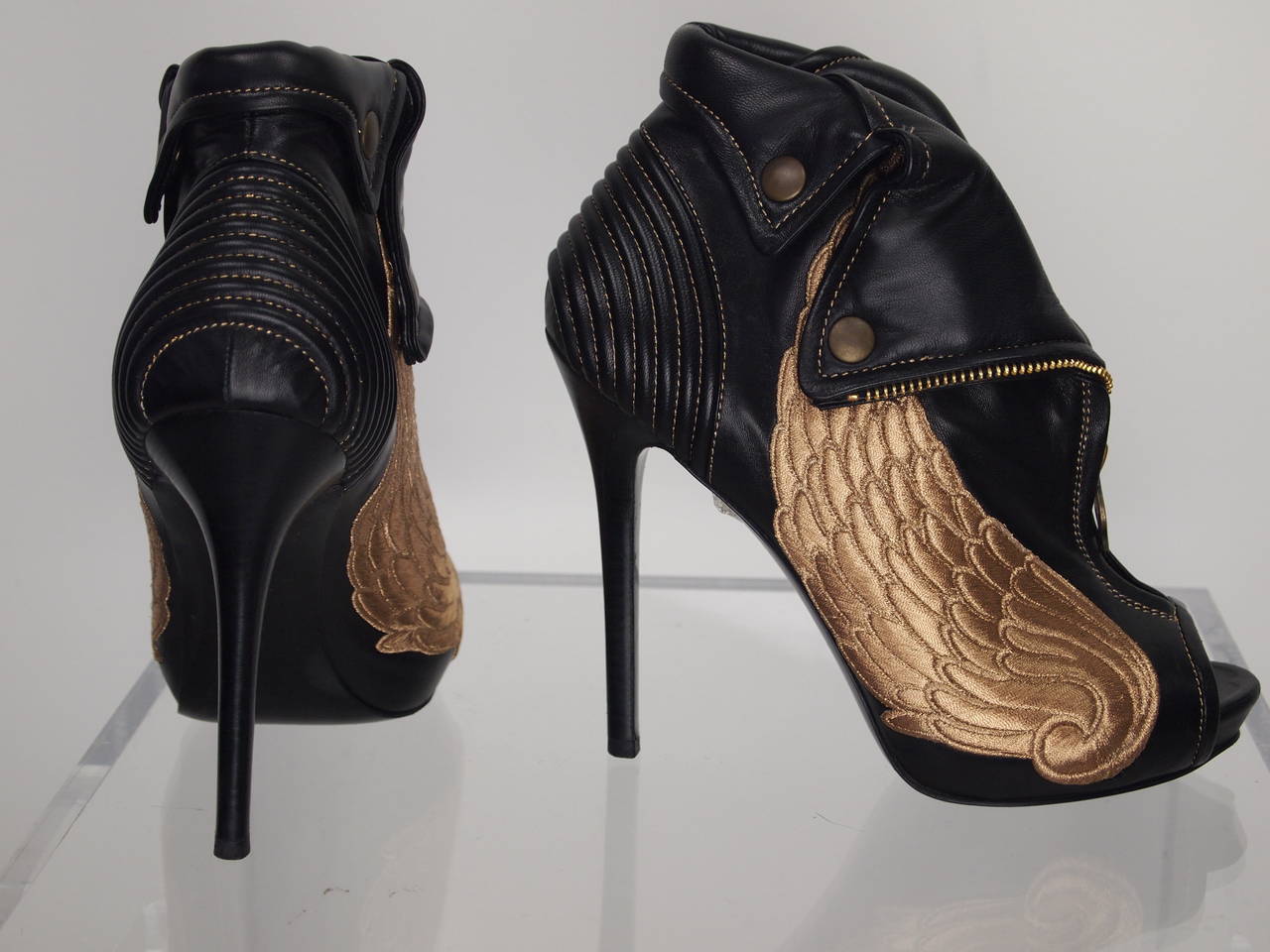 Alexander McQueen, leather peep-toe booties with ribbing at counter, zip detail at front, embroidered wings at sides and stacked heel. Includes box and dust bag.
