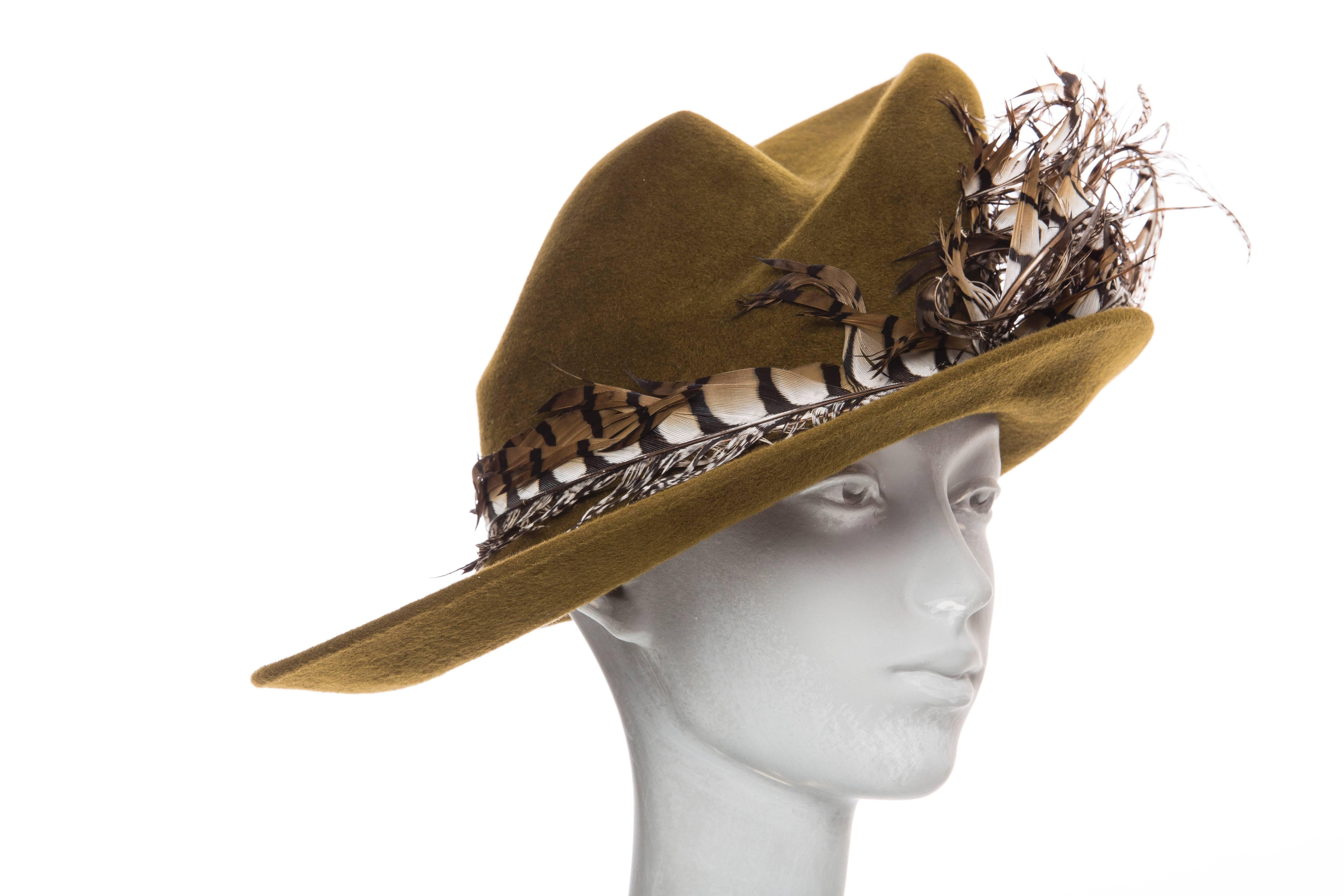 Phillip Treacy olive wool felt hat with feather accents. Includes box.

 Circumference 20