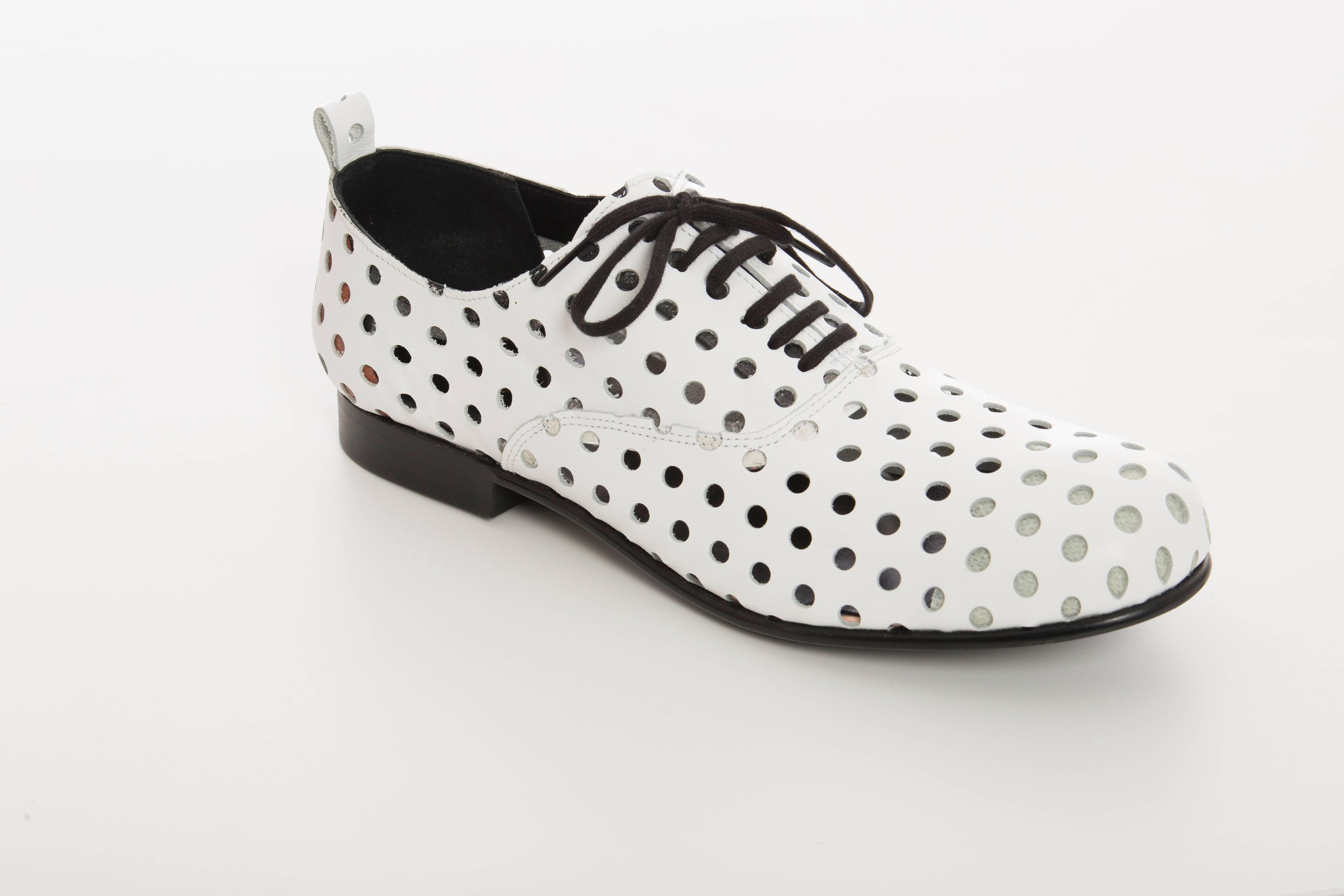 Comme des Garçons, Spring-Summer 2015, white perforated leather oxfords with stacked heels and front lace closure. Includes box.

Japan 26
US 8