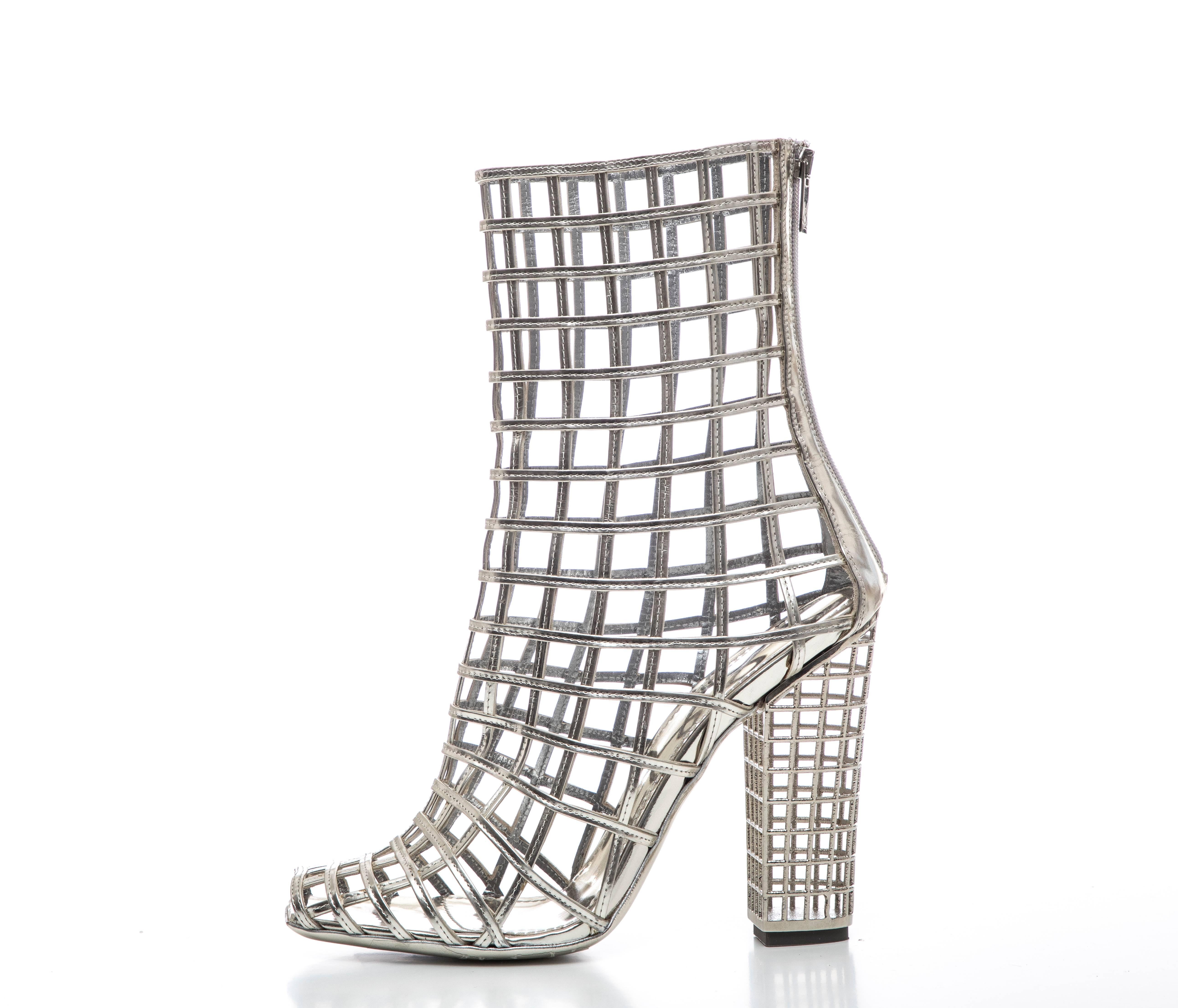 Yves Saint Laurent, Stefano Pilati Spring 2009 silver metallic leather peep-toe caged ankle boots with zip closures at backs and block heels. Includes box and dust bag.

IT. 40, US. 10 

Calf Circumference: 11, Shaft 7, Heels 5
