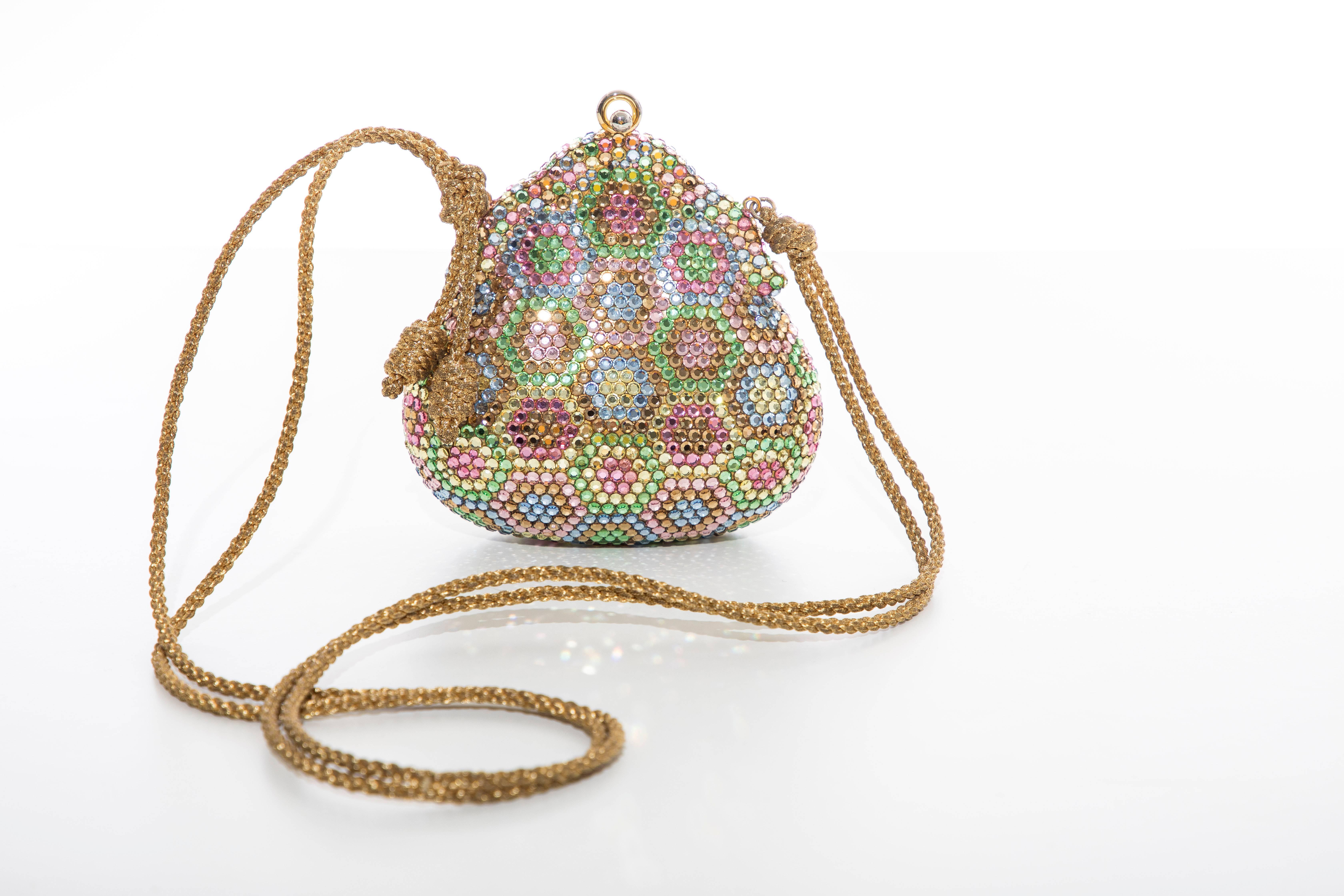 Judith Leiber, circa 1990,s crystal evening, minaudieres bag with gold cord strap, snap closure, comb, coin purse, mirror and fully lined in gold leather. Includes dust bag.

Width: 5, Length: 5, With Strap 21, Depth: 1.5
