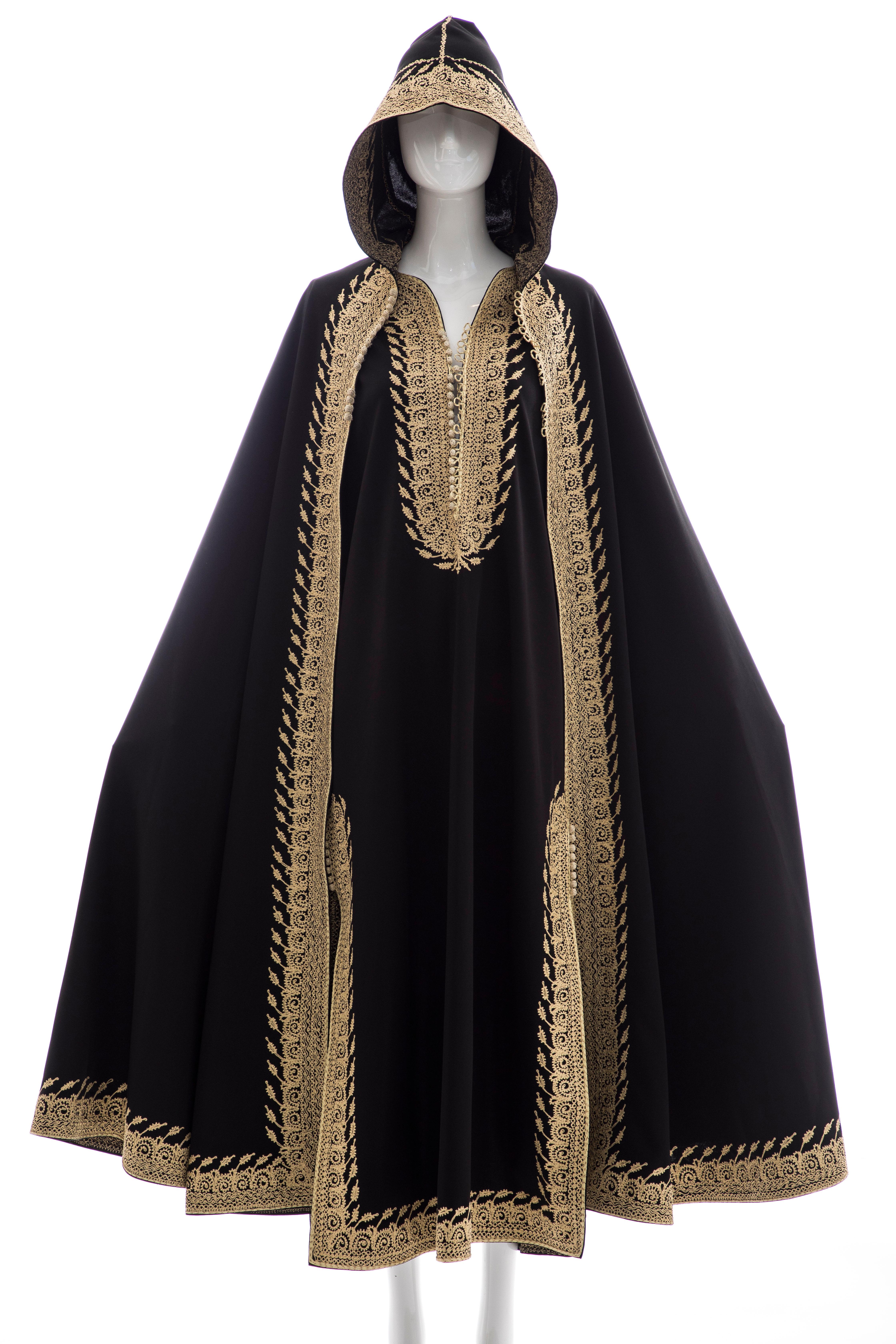 Moroccan Black Kaftan, circa: 1970's  front and side frog closures with gold embroidery, angel sleeves and separate embroidered hooded cape with frog closures.

No Size Label

Bust: 38, Waist: 37, Hips: 40, Length 54