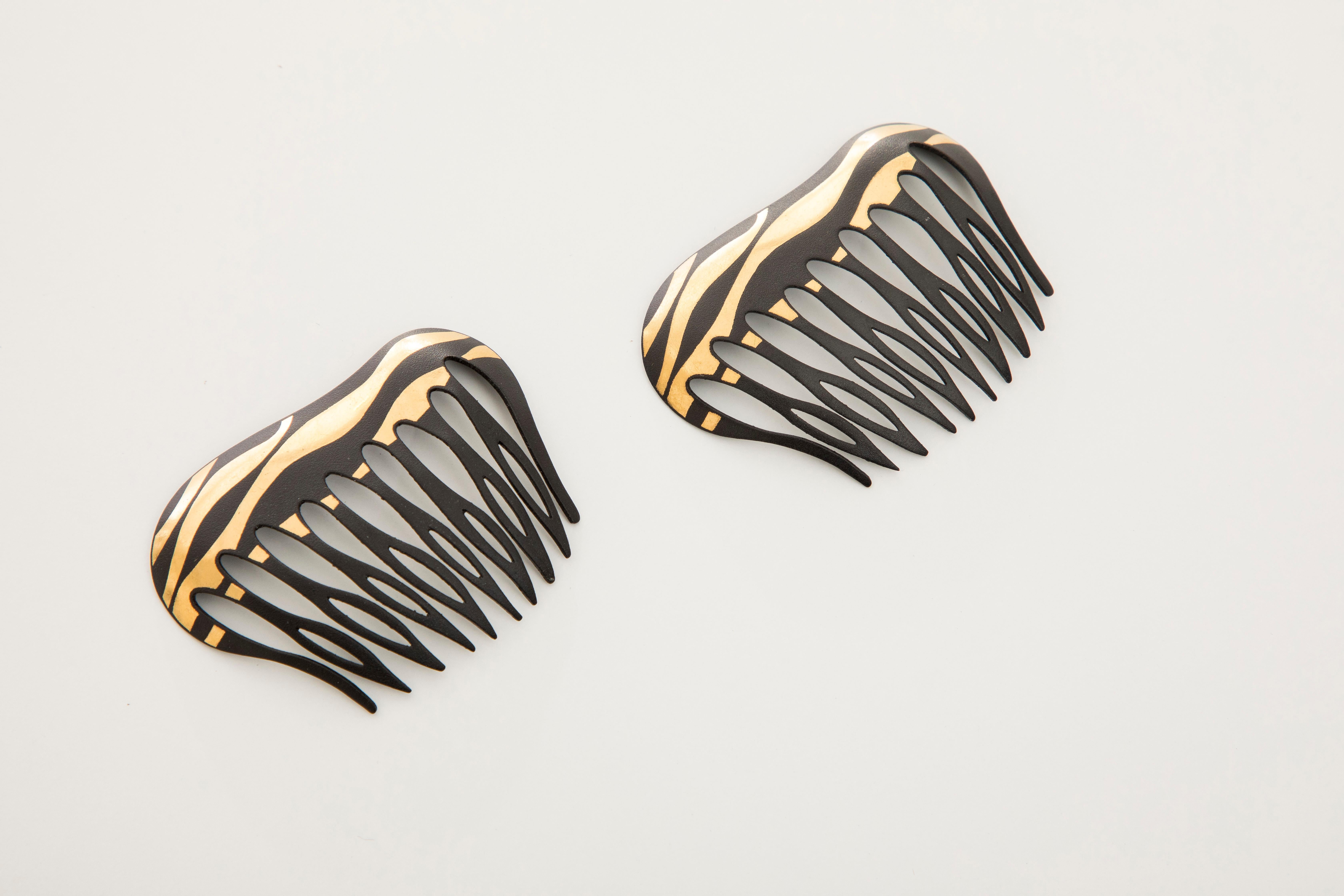 Angela Cummings for Tiffany & Co., Circa: 1970's a pair of Damascene lacquered iron and gold hair combs of striped design, in 22k. 

W 2.38 in.
W 60.46 mm