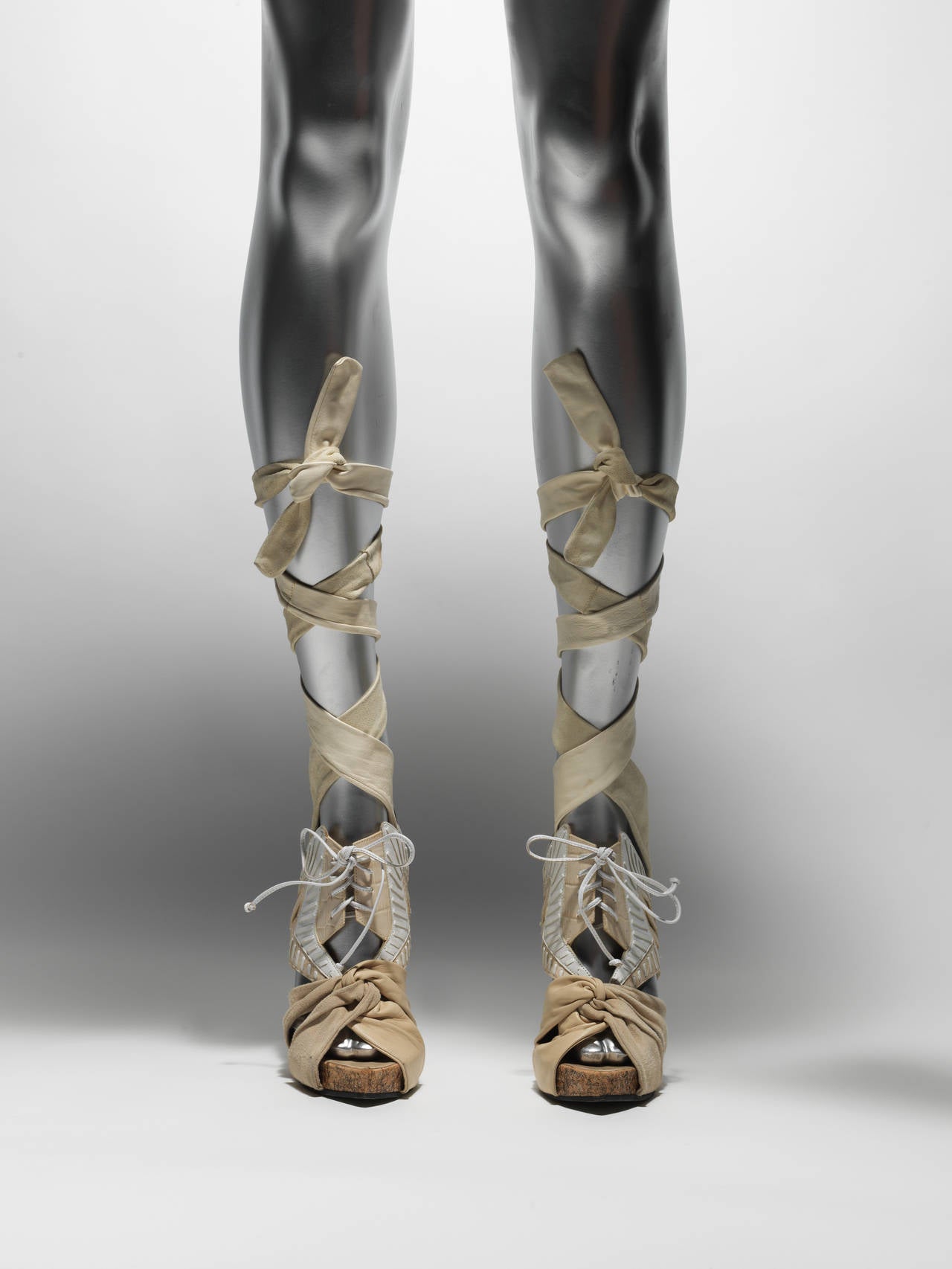 Nicholas Kirkwood for Rodarte, Fall 2010 beige, creme, black suede and embossed leather sandals with wrap-around suede ankle ties, front lace closure and melted effect heels.
Heels 6.5"