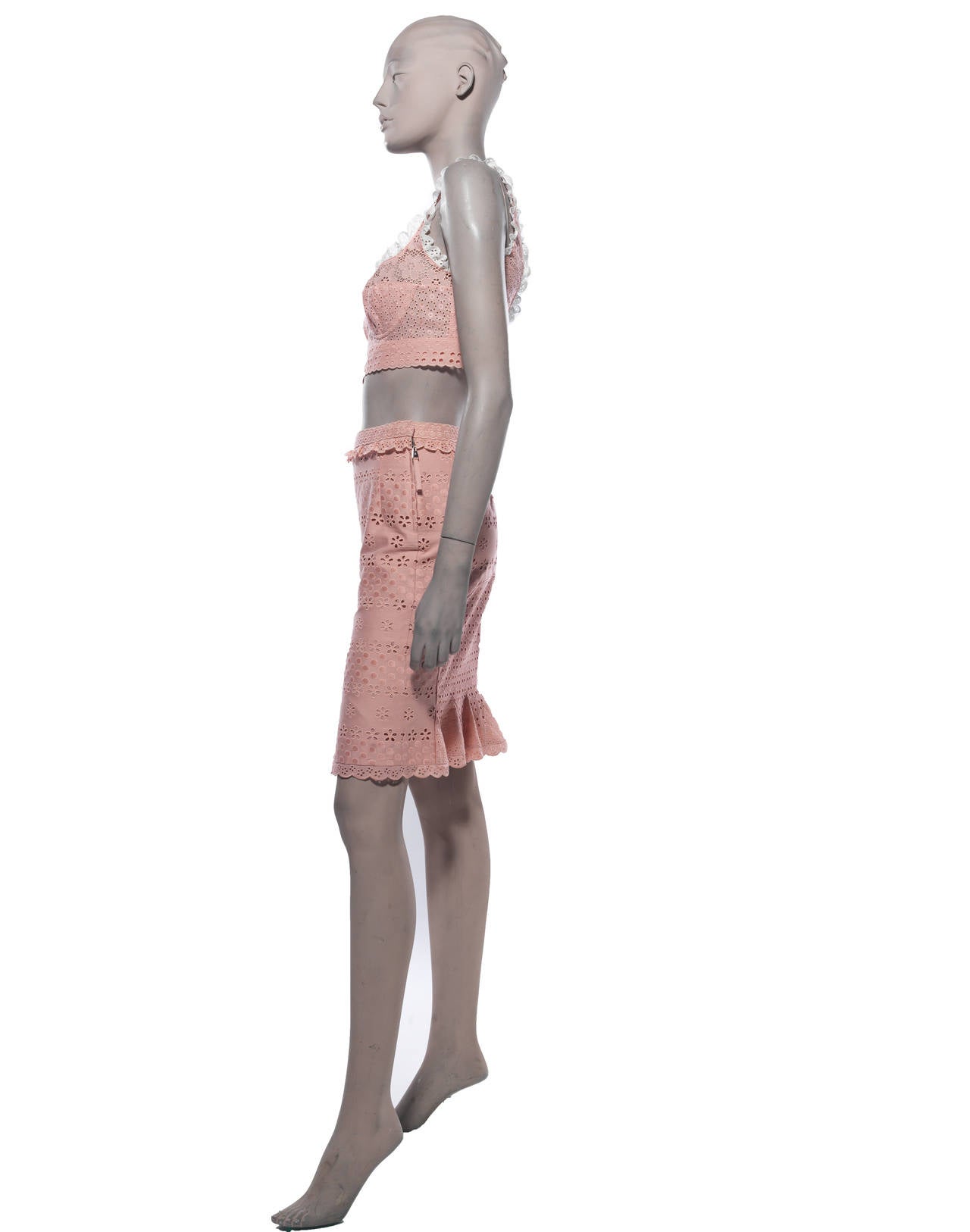 Louis Vuitton Spring 2012, pink and white eyelet skirt set; top features a crop fit, padded bust and back hook closure; skirt features bottom hem pleats and side zip closure.

Top- Bust 30”, Length 15”; Skirt– Waist 28”, Hip 34”, Length