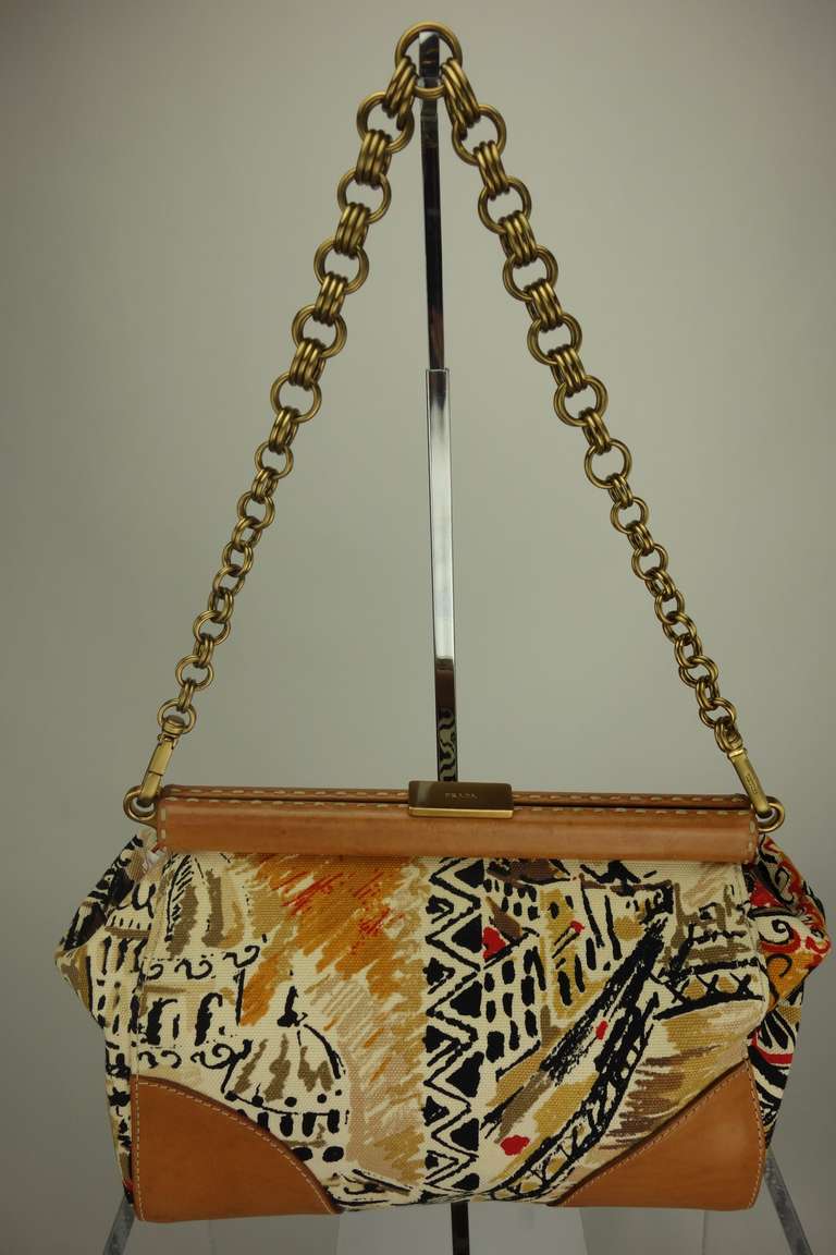 Prada printed canvas and leather handbag with detachable chain link strap, fully lined in leather, one zipped pocket.