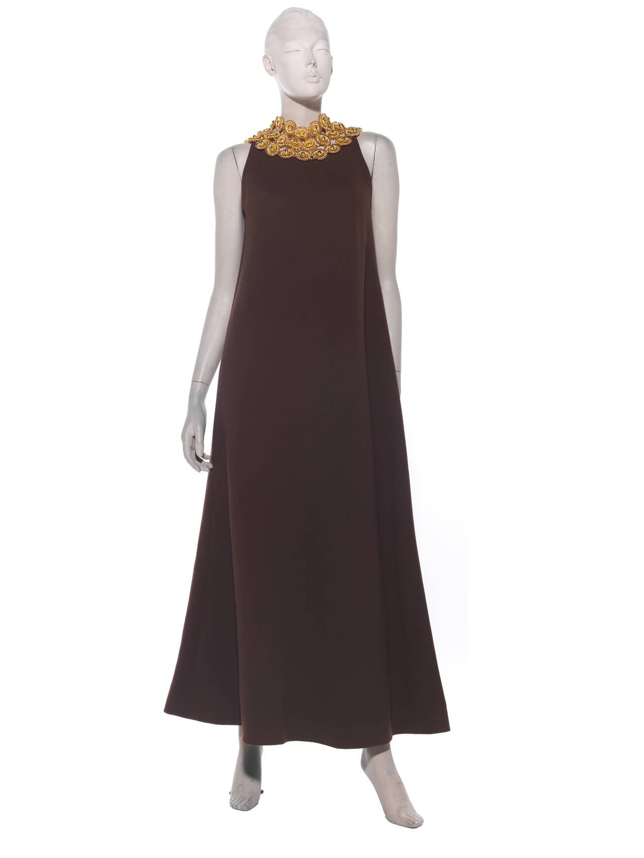 Jacques Heim, circa 1960's A-line, sleeveless, chocolate brown heavy gauge wool-crepe gown, with zip back and fully lined in silk with attached gold-tone neckpiece. 