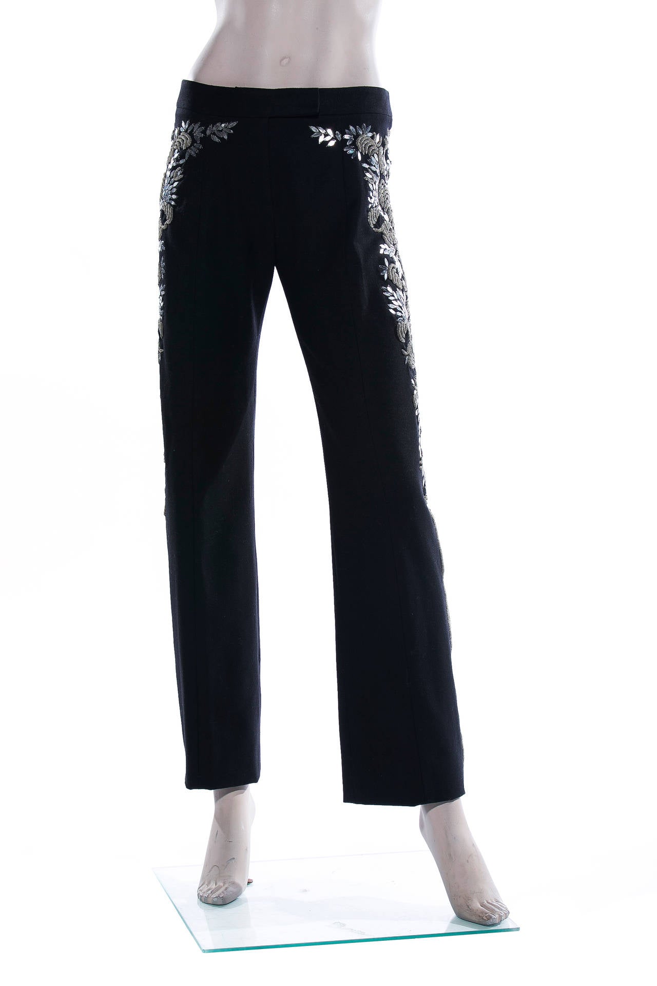 Alexander McQueen, Autumn-Winter 2006, black embroidered wool pants with side panels of raised silver purl wire and elliptical sequined paillettes, front zip.  Size not listed, estimated from measurements.

Waist 29”, Hip 36”, Rise 9.5”, Inseam