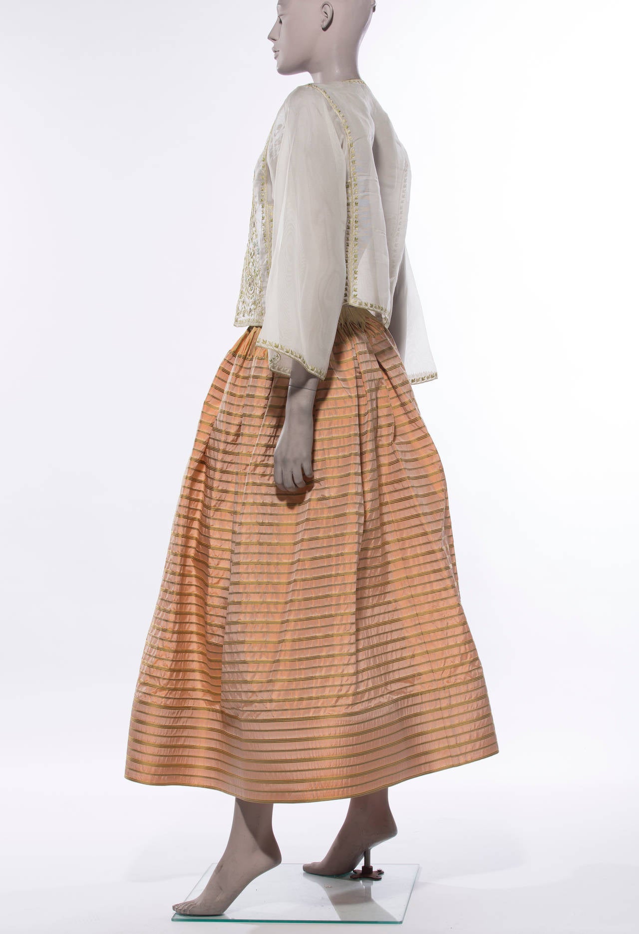 Oscar de la Renta, circa 1990's skirt ensemble. Skirt consists of striped silk taffeta, two front pockets and side snap and hook & eye closure with 6 inch boning at bottom. Floral embroidered, lightweight jacket with hook & eye closure and tassel