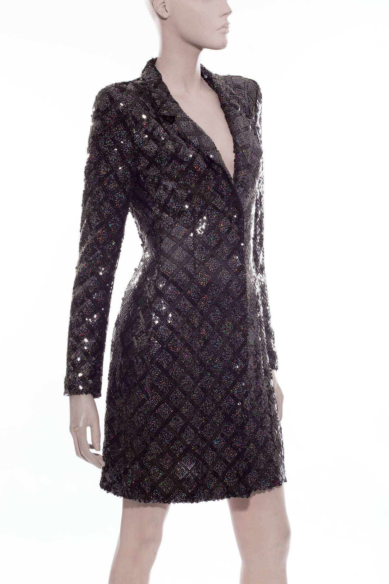 Chanel, Autumn/Winter 2004, black silk coat with diamond pattern sequin embellishment, notched lapels, front snap closure, two front pockets and fully lined in silk chiffon.

Bust 36”, Waist 34”, Shoulder 17”, Length 35”