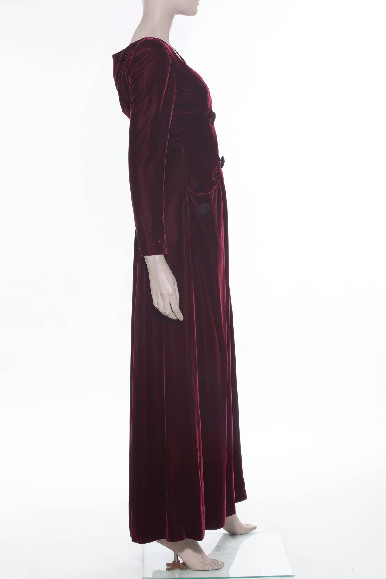 Oscar De la Renta, circa 1990's, silk velvet gown, long sleeves with zip cuffs, snap front, corded buttons, two front pockets and fully lined in silk.