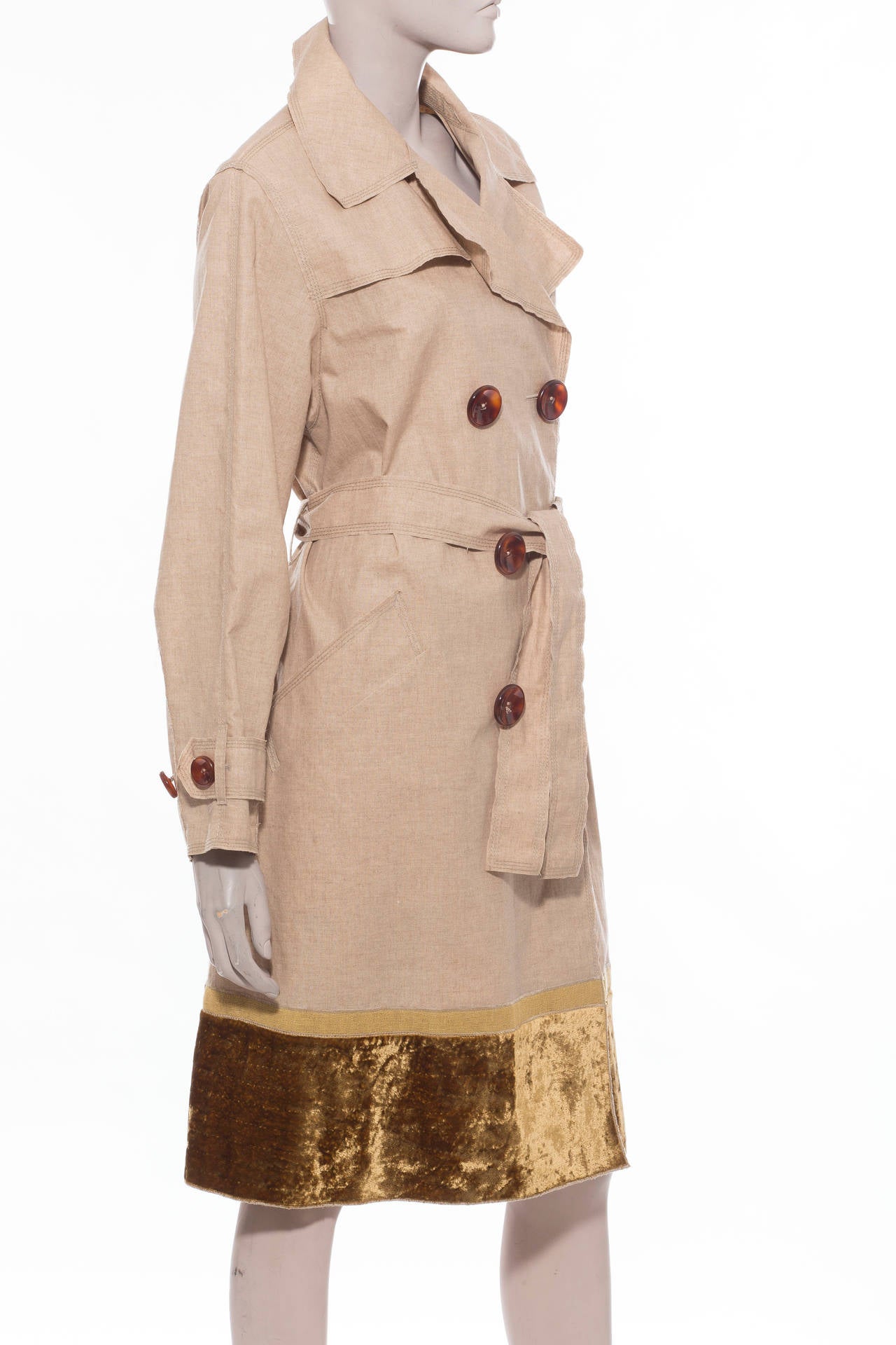 Marc Jacobs for Louis Vuitton,  coated linen, double-breasted coat with notched collar, slit pockets at sides, velvet trim at hem, tie at waist and front button closure.

Bust 44”, Waist 48”, Shoulder 17”, Length 40”