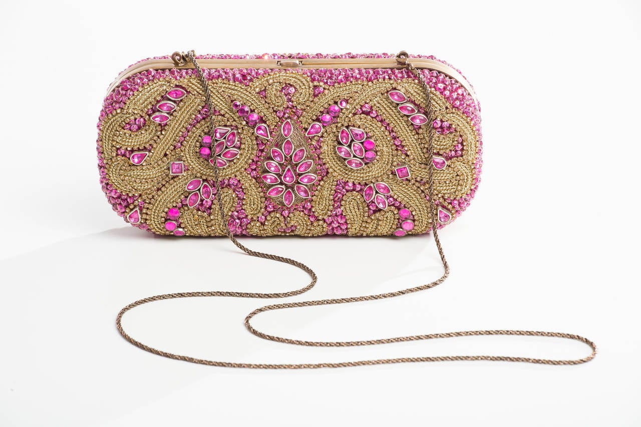 Marchesa jeweled minaudière with antiqued brass hardware, beaded and pavé embellishments throughout, collapsible shoulder strap, taupe woven lining, single slip pocket at interior wall and push-lock closure at top.

Shoulder Strap Drop 20”,