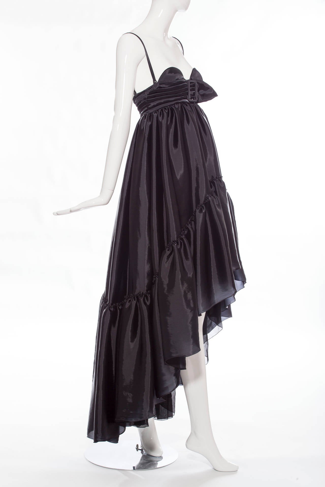 Jean Paul Gaultier, circa 1990s sleeveless gown with empire waist, tiered ruffled panels at hem, built-in bra featuring pleated accents, adjustable straps and hook and eye closures at center back.

Bust 28