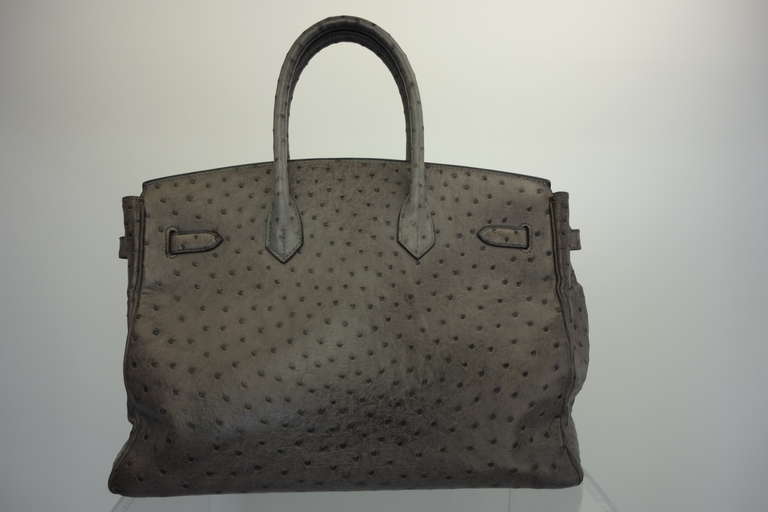 Hermes 35 Cm graphite ostrich handbag with palladium hardware, lock and key, two interior pockets with one zip and dust bag.