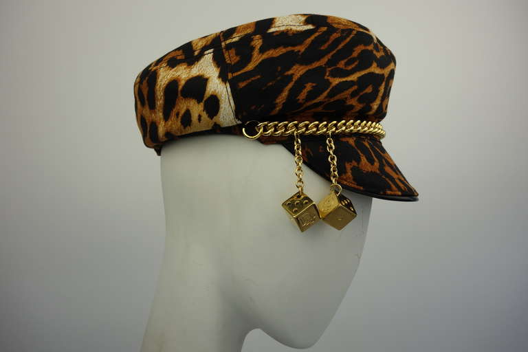 Christian Dior leopard hat with gold chain and dice detail.