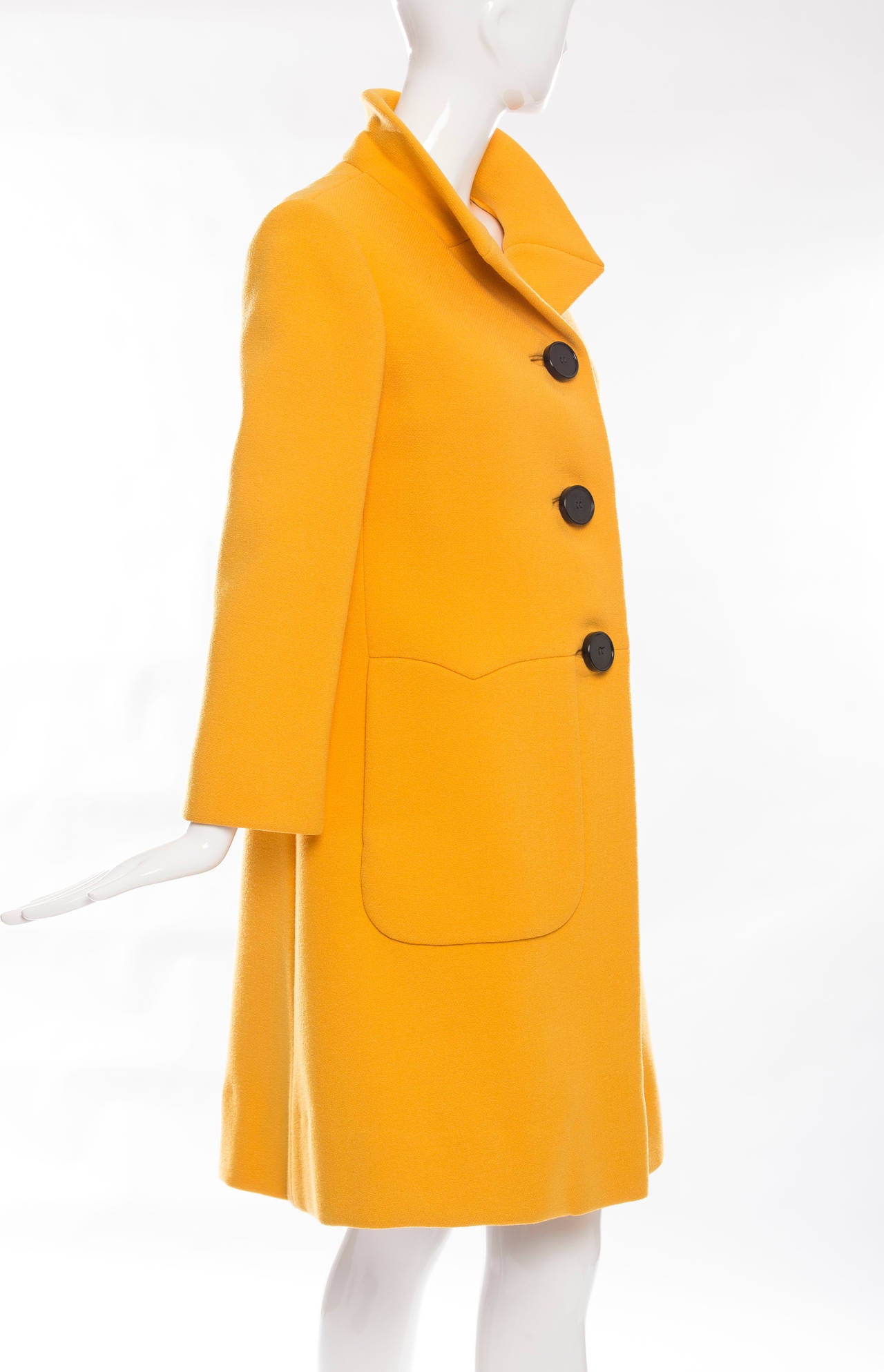 Pauline Trigere yellow wool coat, three large self buttons, two side pockets and fully lined in satin.