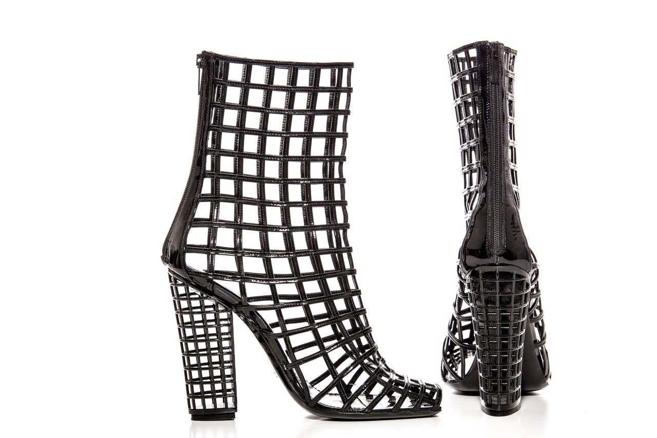 Yves Saint Laurent, Spring 2009 black patent leather peep-toe caged ankle boots with zip closures at backs and block heels.